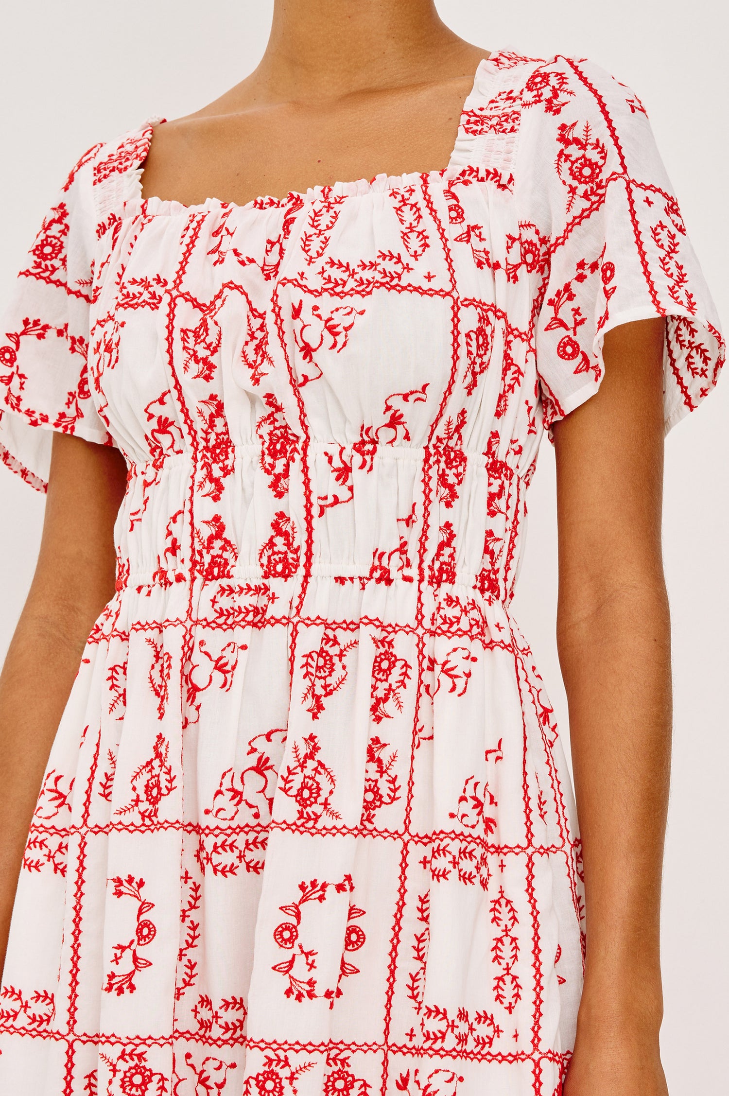 Nanette Midi Dress in Cotton Voile With Square Neckline, Underbust Elastic, Smocked Detailing, Short Sleeves, and is Fully Lined in Ivory Red Handkerchief Colorway - Upper Body Front View Featured on Model
