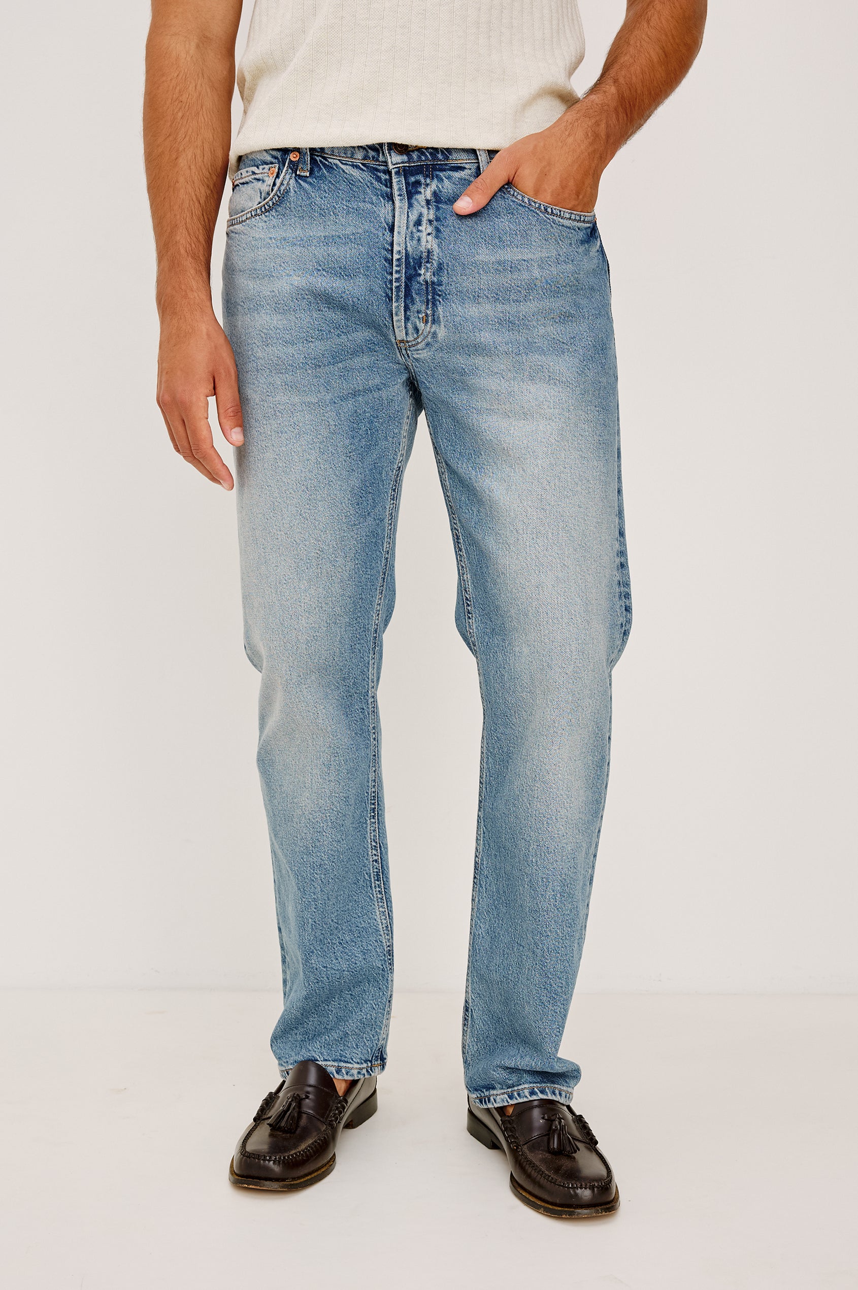 Nash is a straight leg 5-Pocket denim jean a zip fly and button closure as well as rivets in a Medium Vintage Wash. Front full body view featured on model.