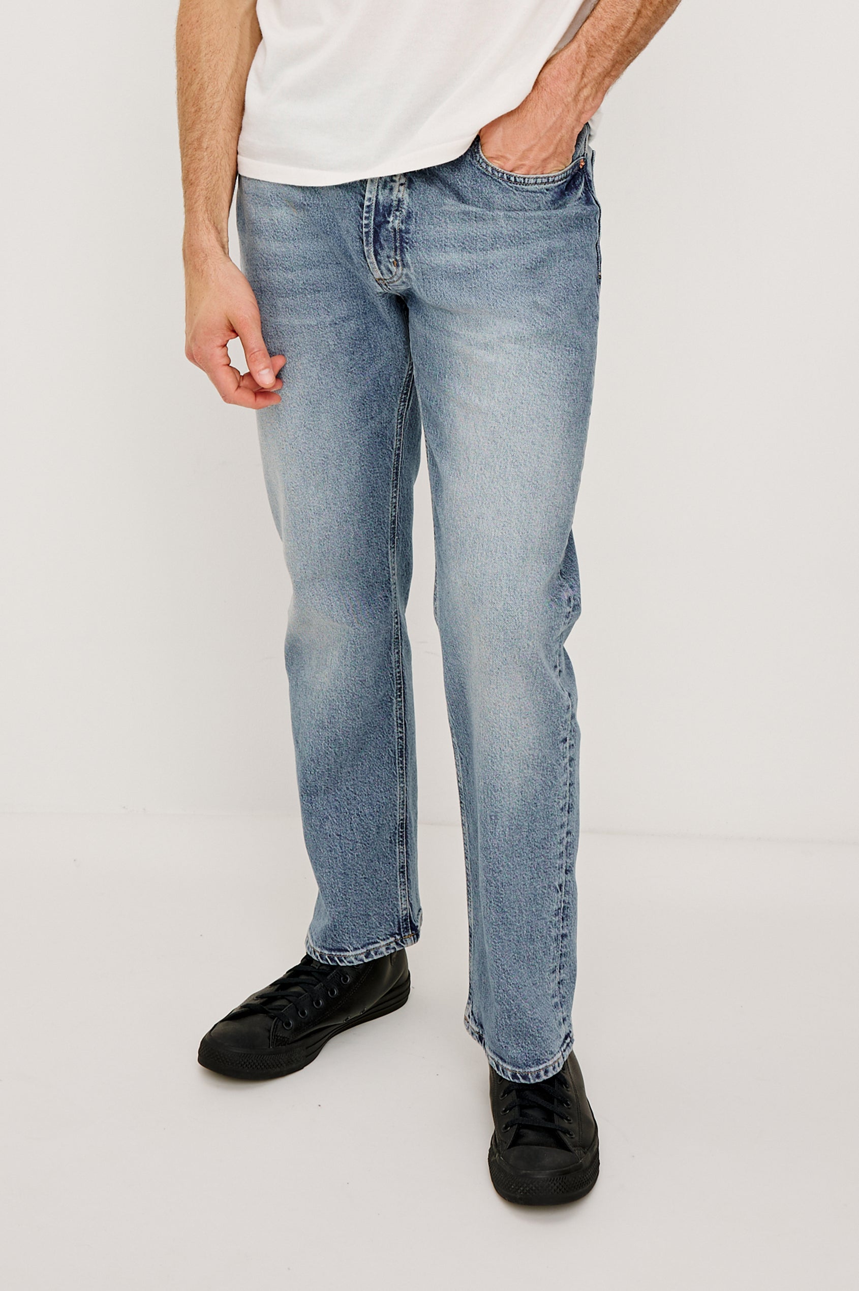 Nash is a straight leg 5-Pocket denim jean a zip fly and button closure as well as rivets in a Medium Vintage Wash. Front full body view featured on model.
