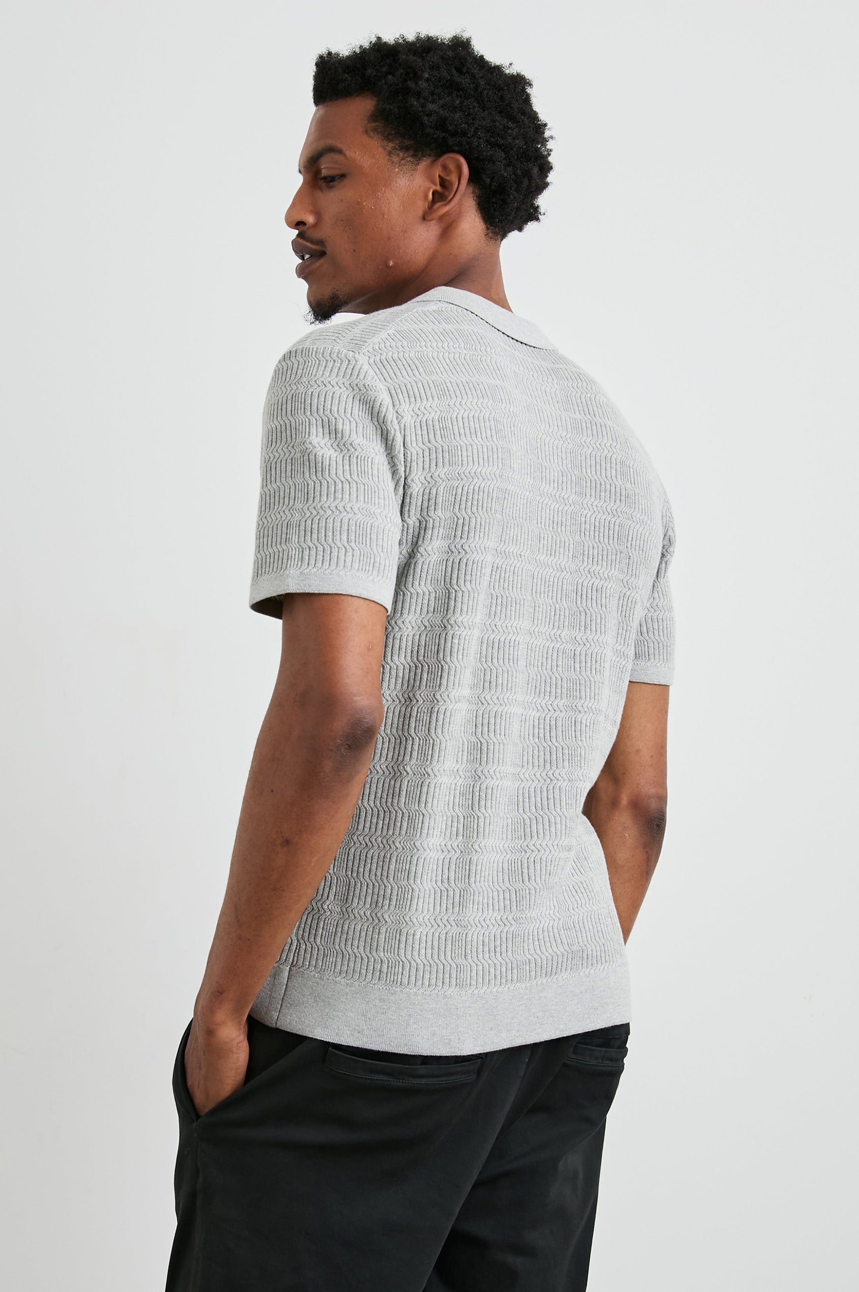 Nathan Short-Sleeve Polo Shirt with a Three-Button Placket and a Jacquard Pattern in Concrete Melange Colorway - Back View Featured on Model