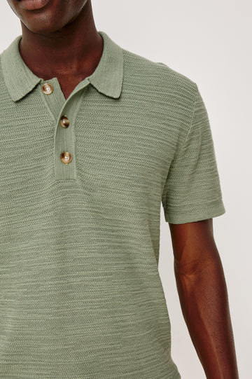 Nathan Polo Shirt in Cotton Blend Knit With Collar, Quarter Button Placket, and Short Sleeves in Silver Sage Colorway - Upper Body Front Close Up View Featured on Model