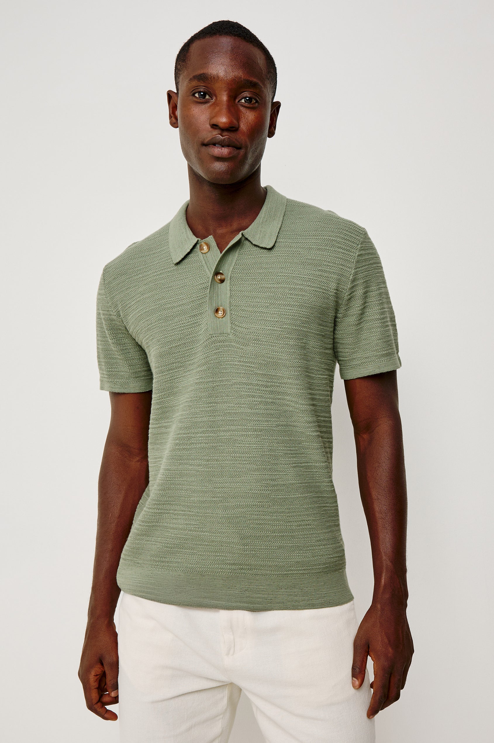 Nathan Polo Shirt in Cotton Blend Knit With Collar, Quarter Button Placket, and Short Sleeves in Silver Sage Colorway - Upper Body Front View Featured on Model