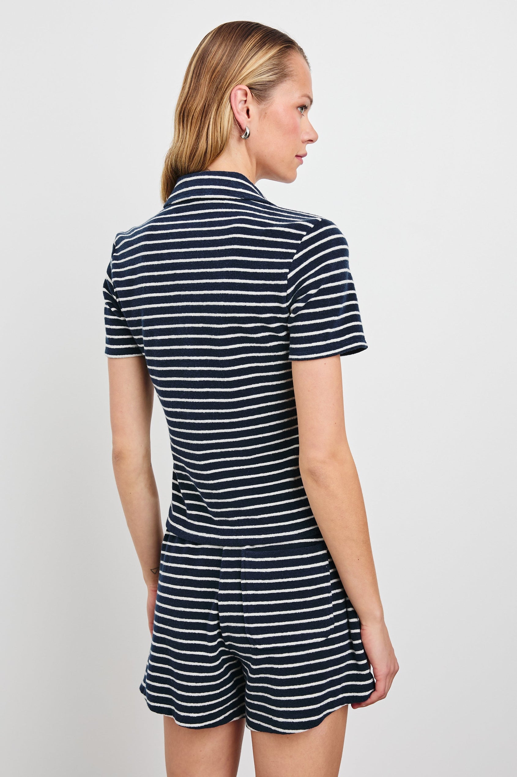 Naveli Court Polo with a Button-Up Placket in Navy Ivory Stripe Colorway, Horizontal Stripes - Back View Featured on Model