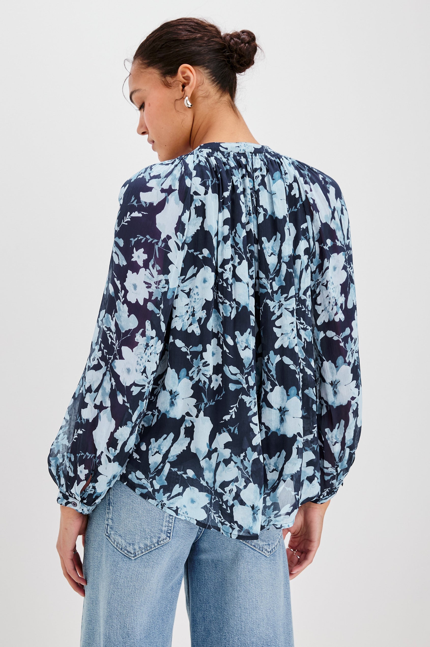 Nessie Long Sleeve Top with Front Button Closure and Ruching along the Neckline in Indigo Blossoms Colorway, Flowers in Blue on Indigo - Back View Featured on Model 
