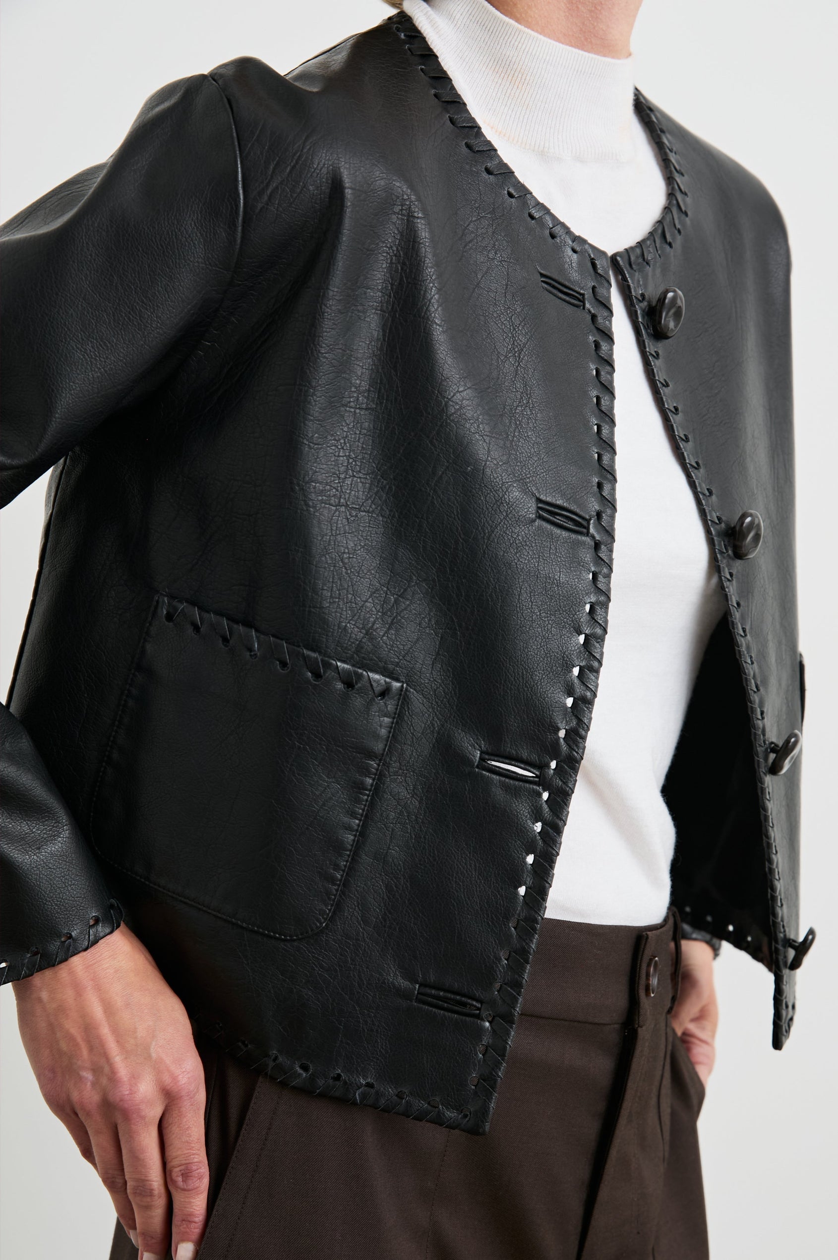 Nevina Jacket with Button Closure, Whip Stitch Trim and Two Front Patch Pockets in Black Colorway - Front View Featured on Model