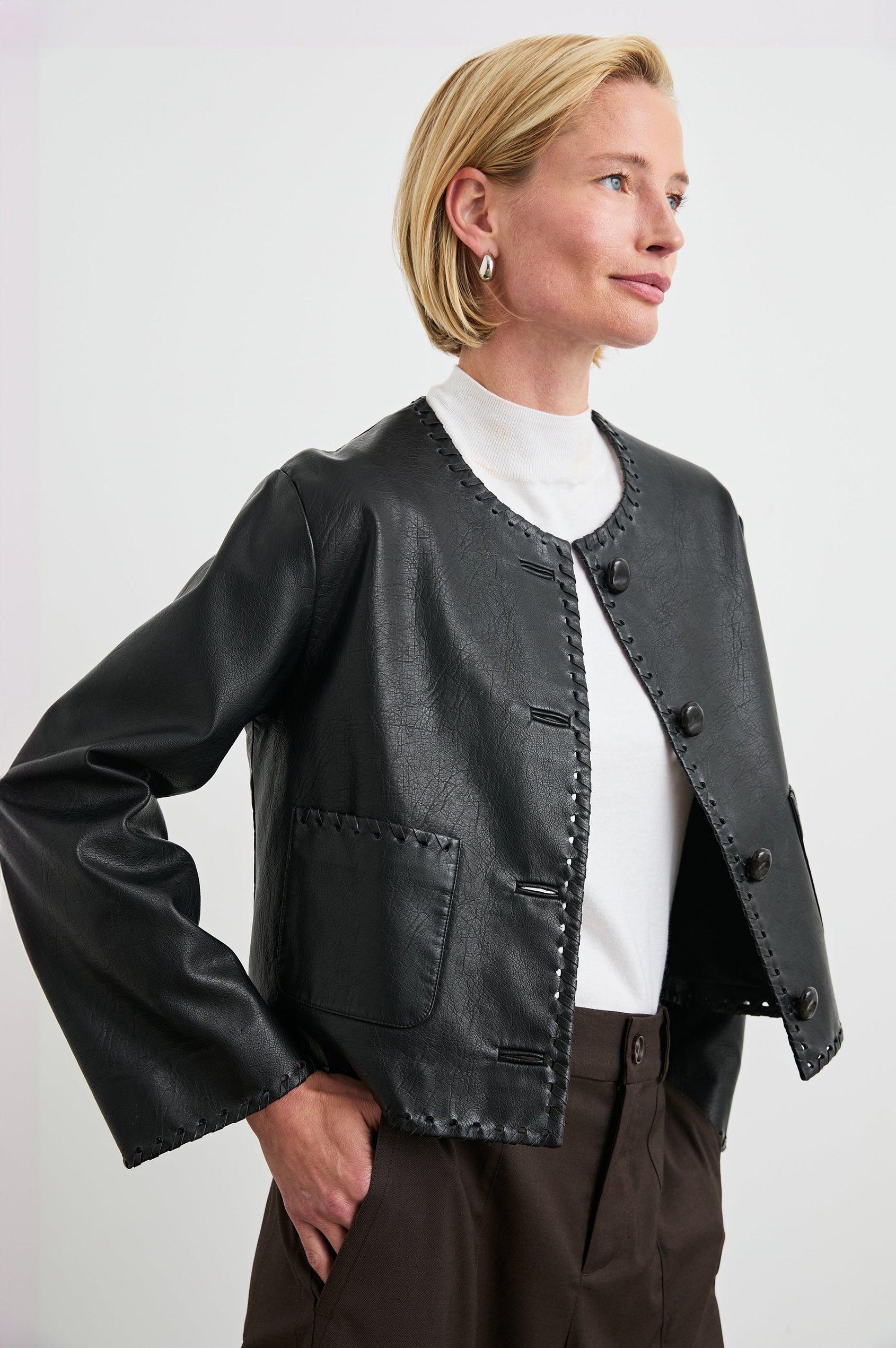 Nevina Jacket with Button Closure, Whip Stitch Trim and Two Front Patch Pockets in Black Colorway - Front View Featured on Model