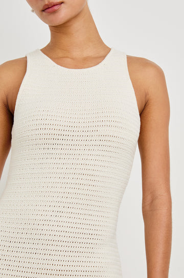 Close up detail shot of female model wearing our sleeveless, Nia Midi Dress in color Ecru, featuring crochet structure and thick straps.