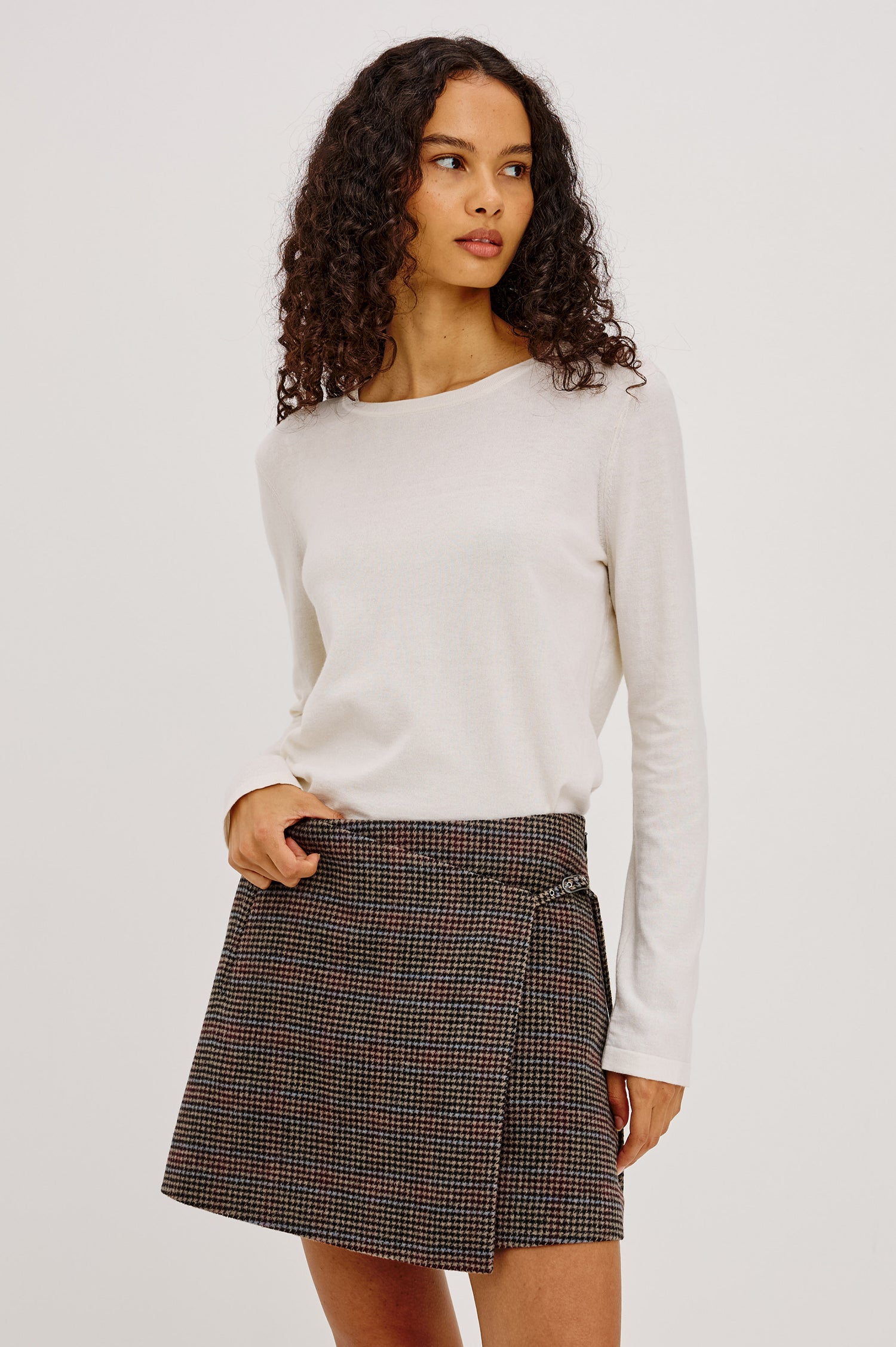 Nial Mini Skirt in Wool Blend With Wrap Front, Buckled Side Strap, Side Welt Pocket, Seam Zip Closure, and Fully Lined in Oxford Plum Colorway - Upper Body Front View Featured on Model