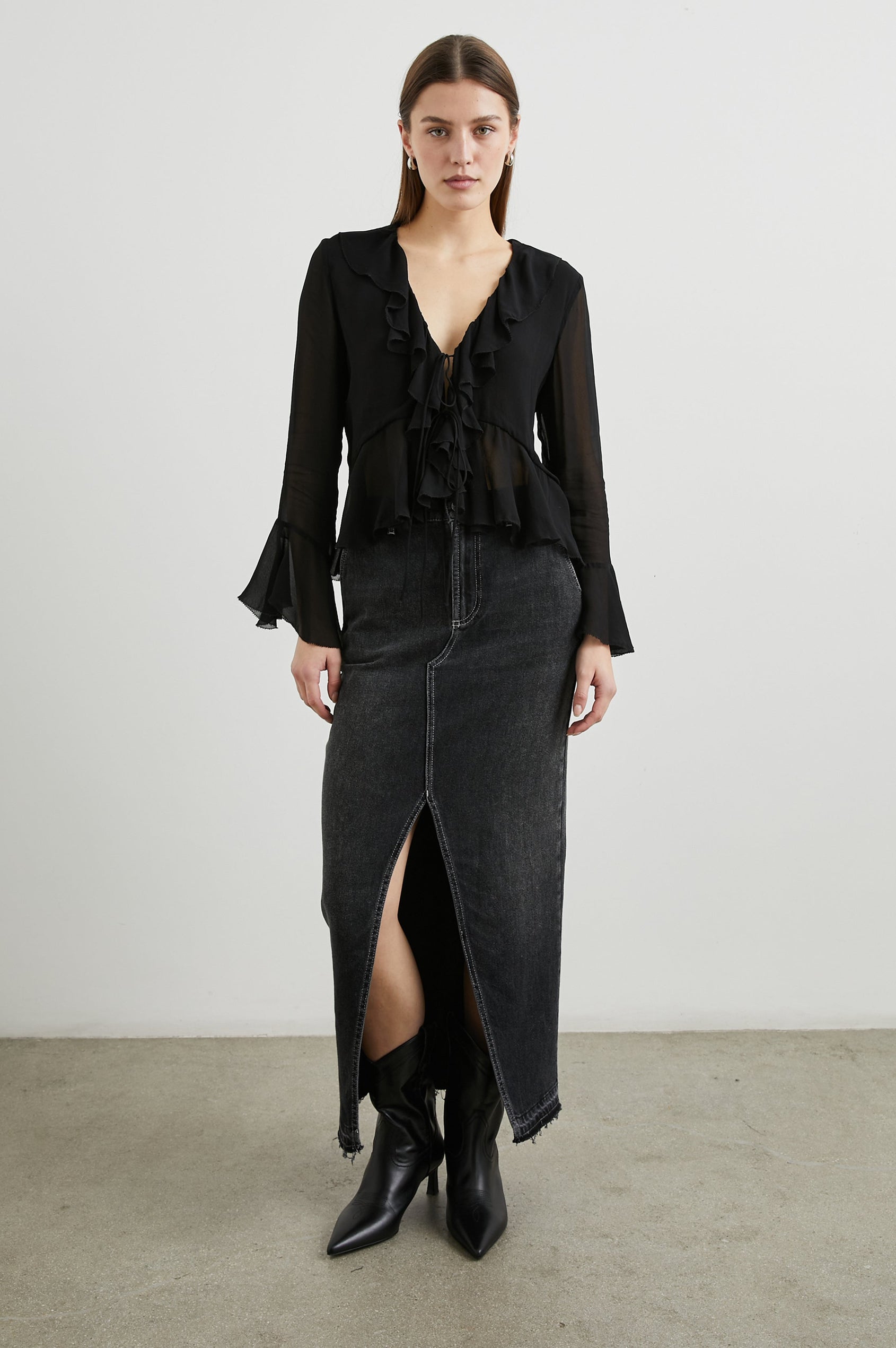 Nicoletta Long-Sleeve Semi-Sheer Top with Deep V Neck, Front Tie Closure, and Ruffled Trim in Black Colorway - Front Full Body View Featured on Model