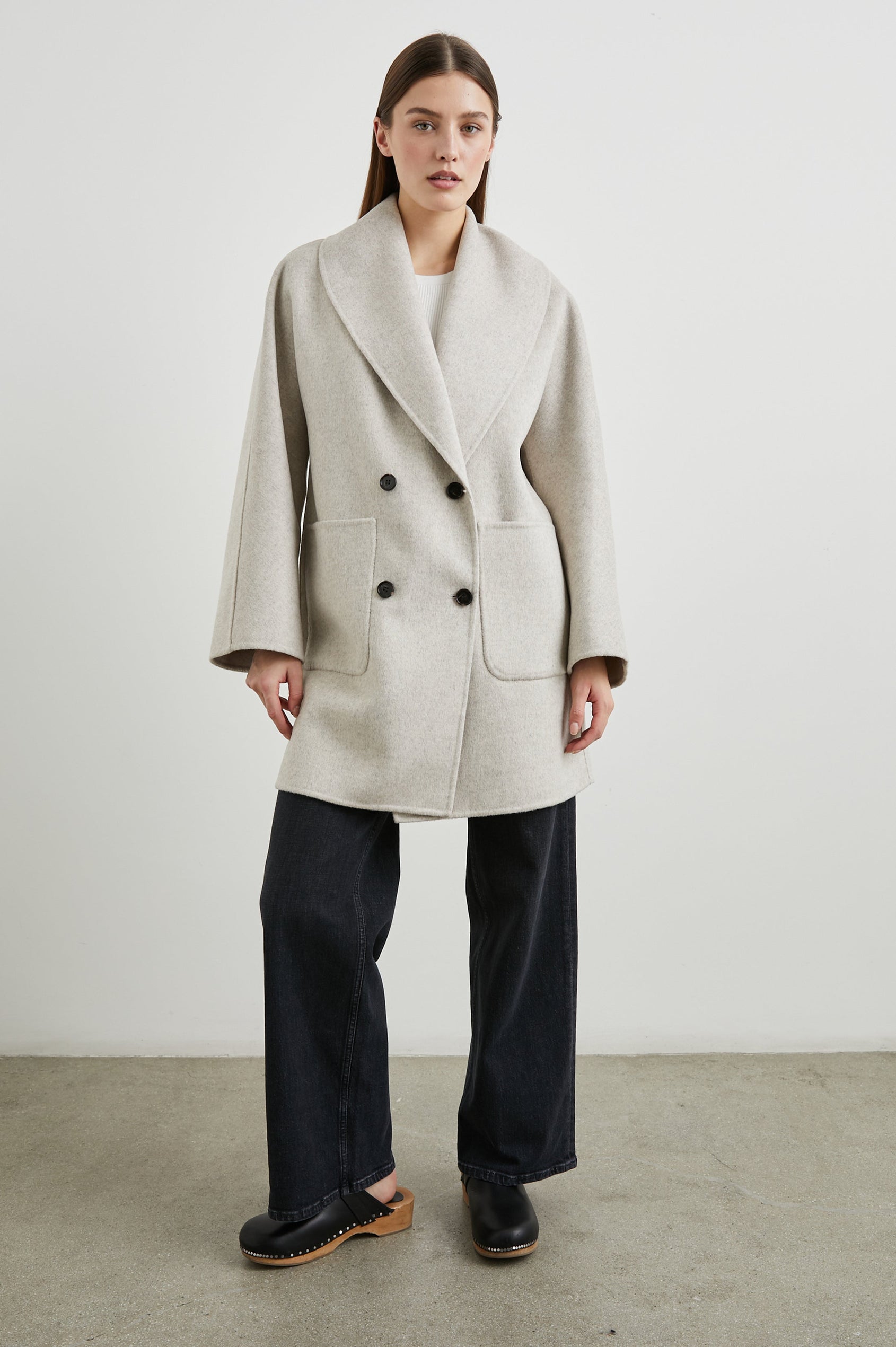 Nily Mid-Thigh Length, Double-Breasted Coat with Two Button Closure, Two Front Patch Pockets and a Shaw Collar in Oatmeal Colorway - Front Full Body View Featured on Model 