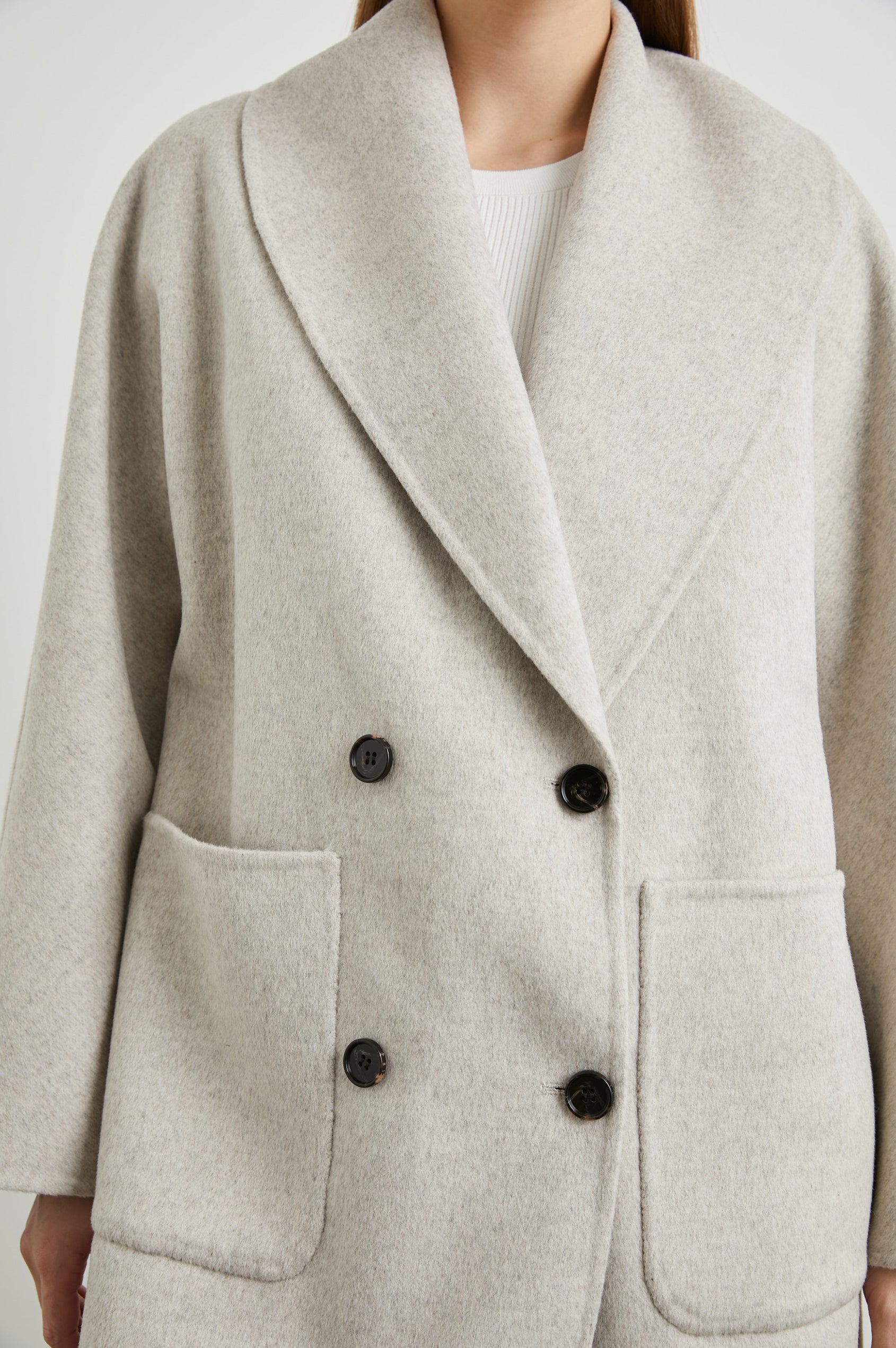 Nily Mid-Thigh Length, Double-Breasted Coat with Two Button Closure, Two Front Patch Pockets and a Shaw Collar in Oatmeal Colorway - Front View Featured on Model 