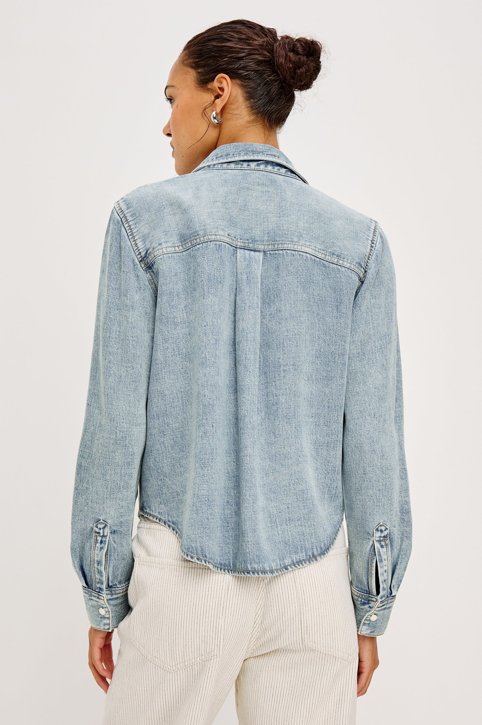 Noa Button-Up Shirt in Denim With Collar Front Buttons Single Chest Patch Pocket and Boxy Fit in Faded Indigo Colorway - Upper Body Front View Featured on Model