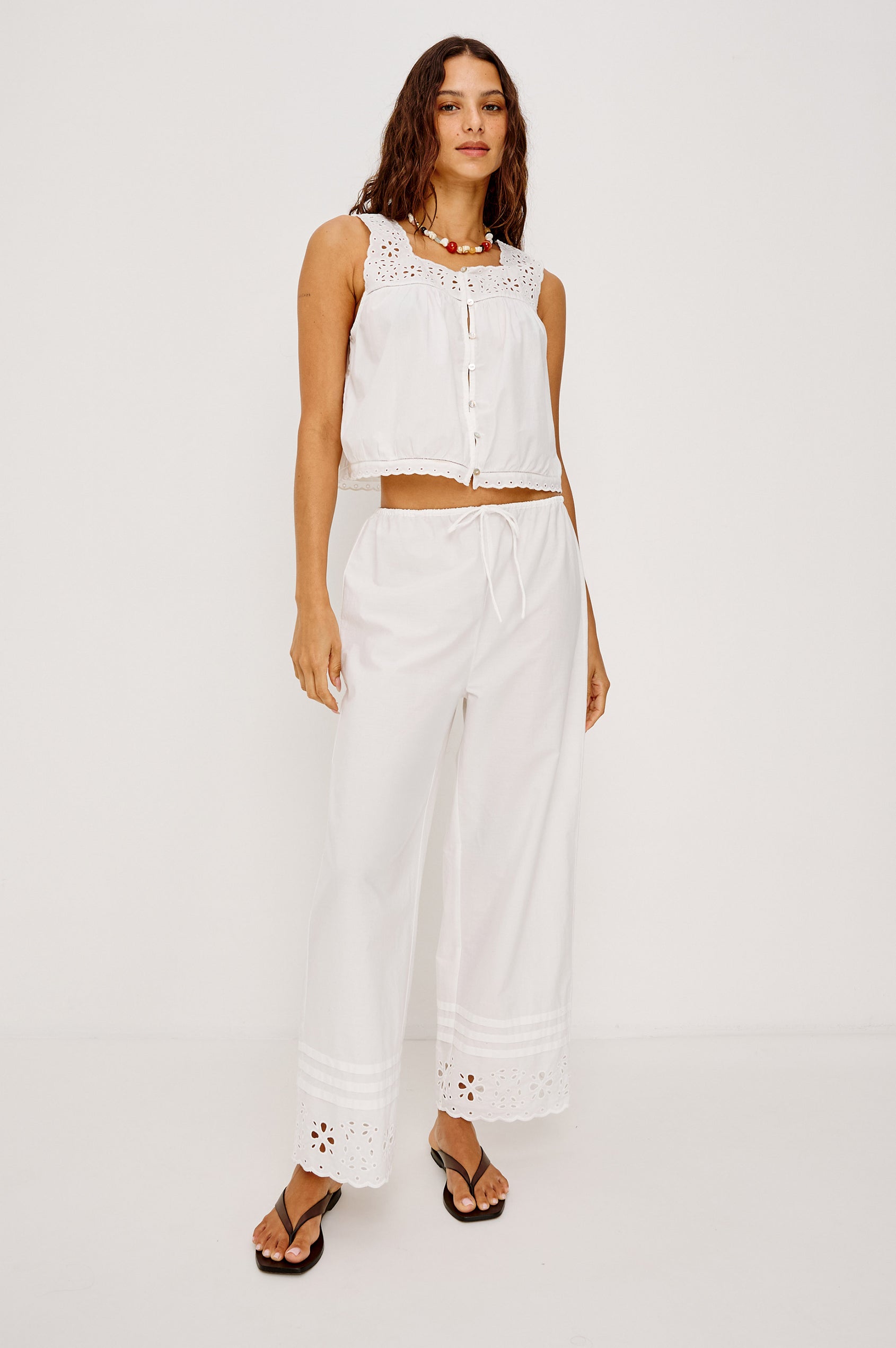 Noemi Sleeveless Top in Cotton Poplin With Square Neckline, Embroidered Shoulder Straps and Yoke, Mini Ladder Trim, Center Button-Loop Closures, and is Unlined in White Colorway - Full Body Front View Featured on Model