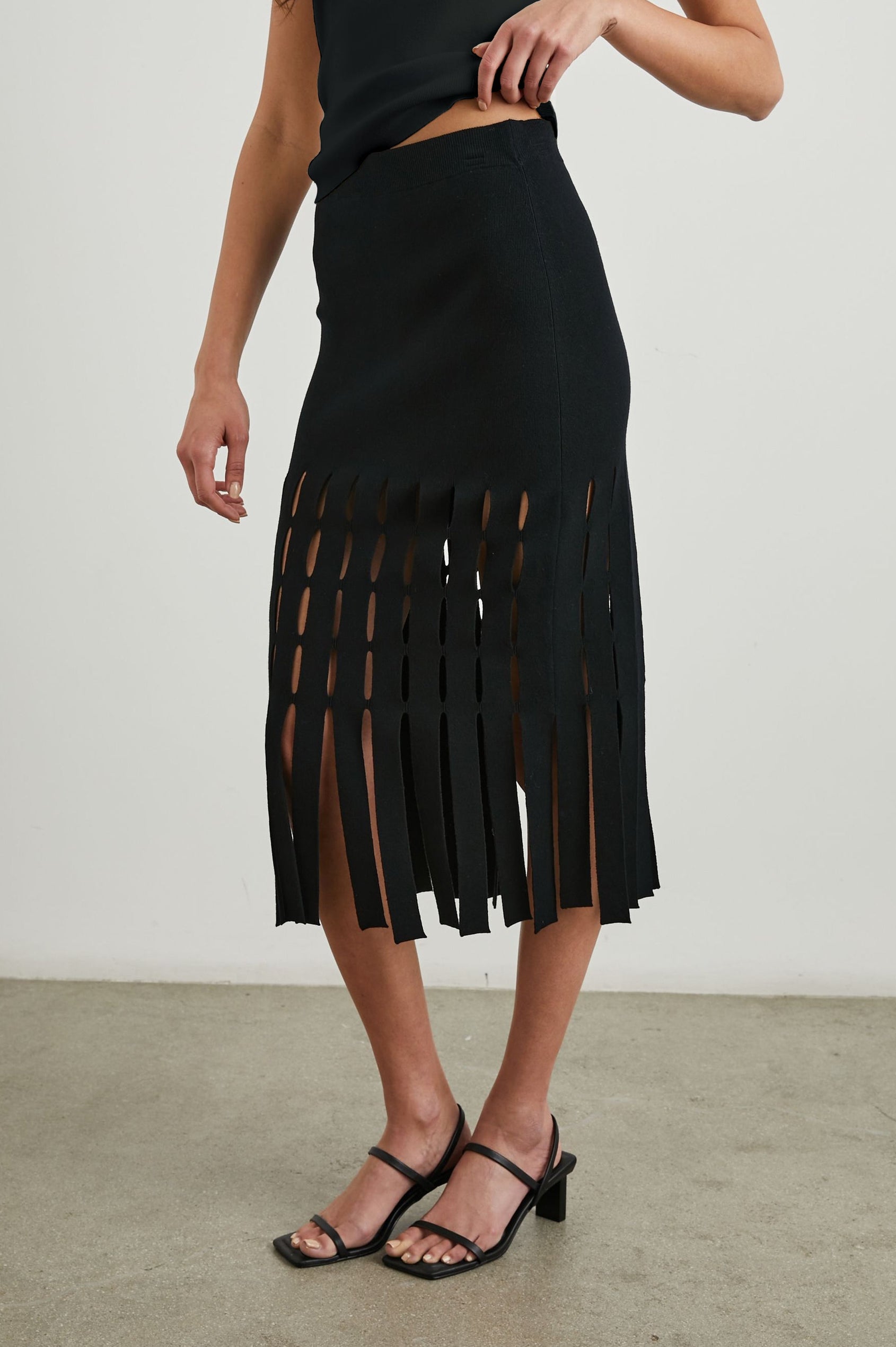 Nola Midi Skirt with Cutouts from the Mid-Thigh Down and Ending in Cut Panels in Black Colorway - Front View Featured on Model 
