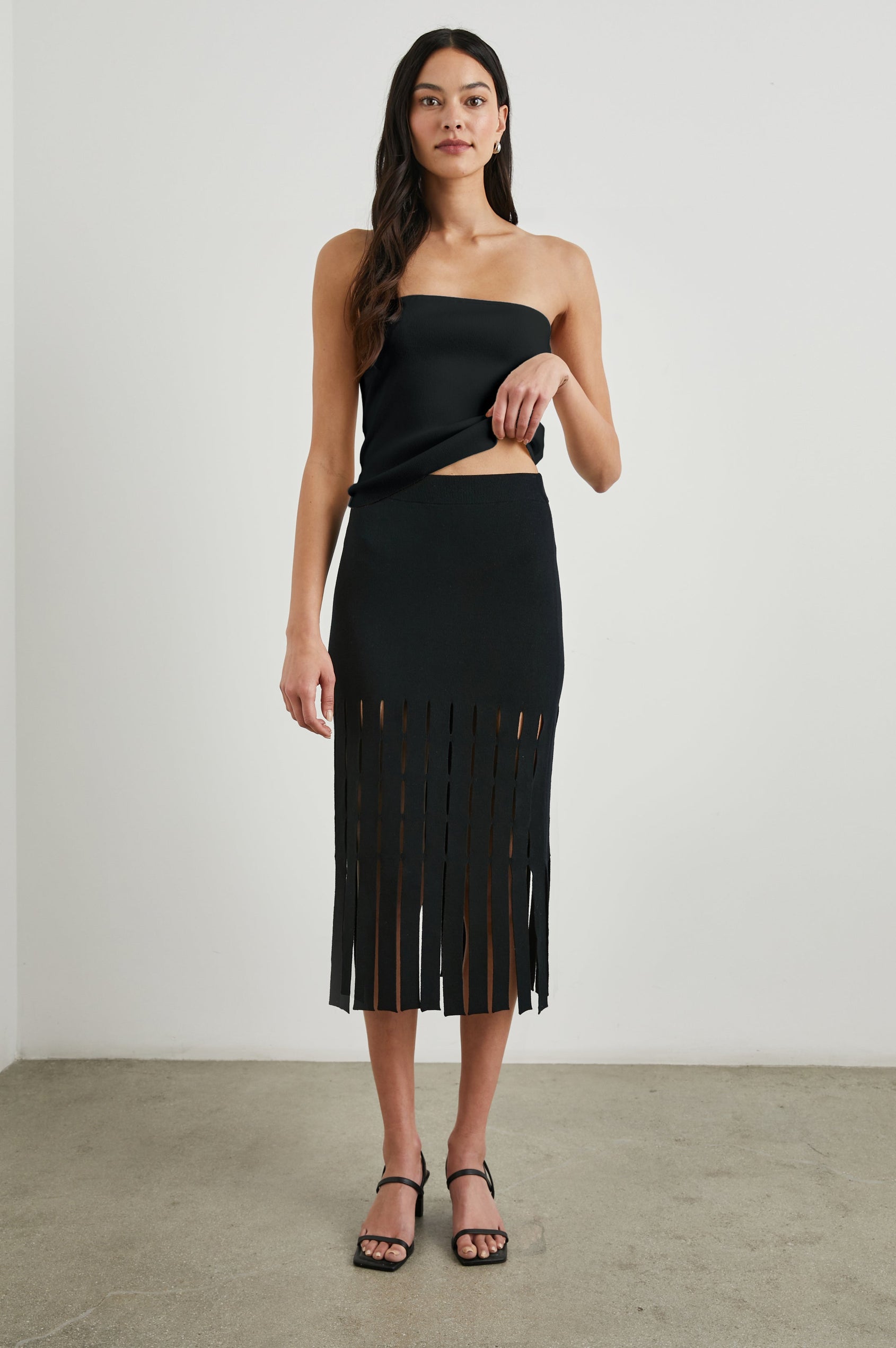 Nola Midi Skirt with Cutouts from the Mid-Thigh Down and Ending in Cut Panels in Black Colorway - Front Full Body View Featured on Model 