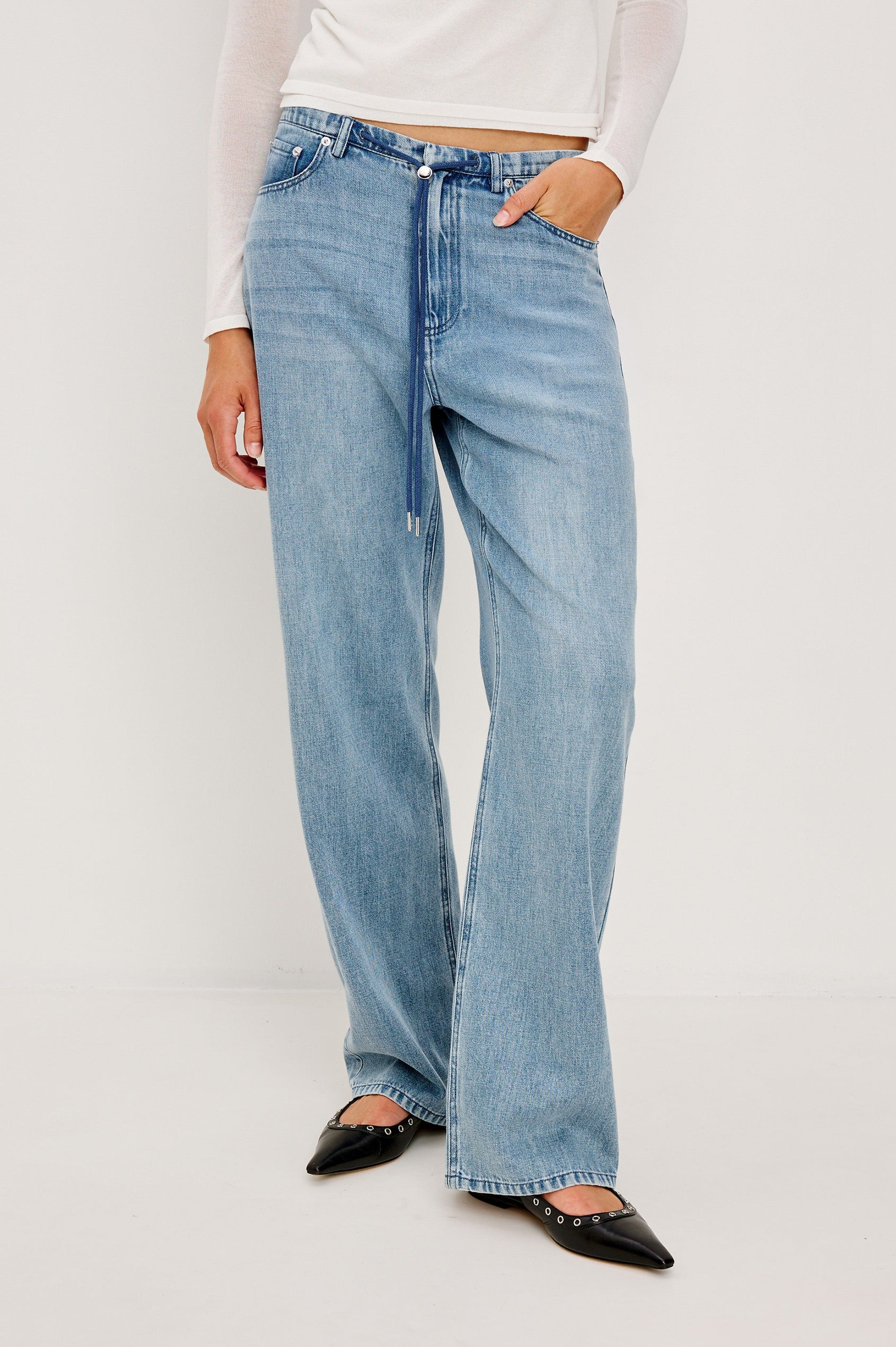 Normandie Lightweight 5-Pocket Denim Wide Leg Pant with front zipper button fly and a drawstring tie at waist in Antique Blue Colorway. Front View Featured on Model.