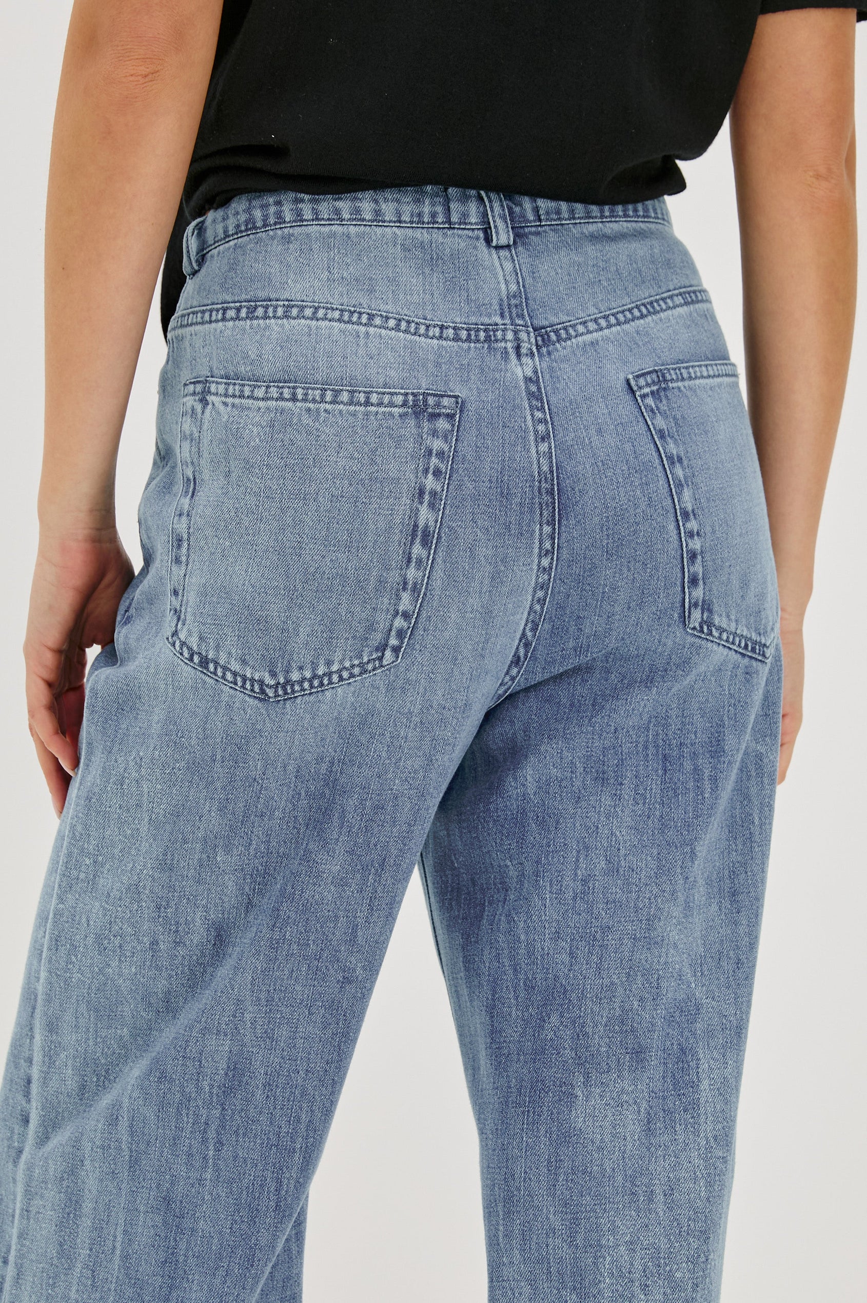 Normandie Lightweight 5-Pocket Denim Wide Leg Pant with front zipper button fly and a drawstring tie at waist in Antique Blue Colorway. Back View Featured on Model.