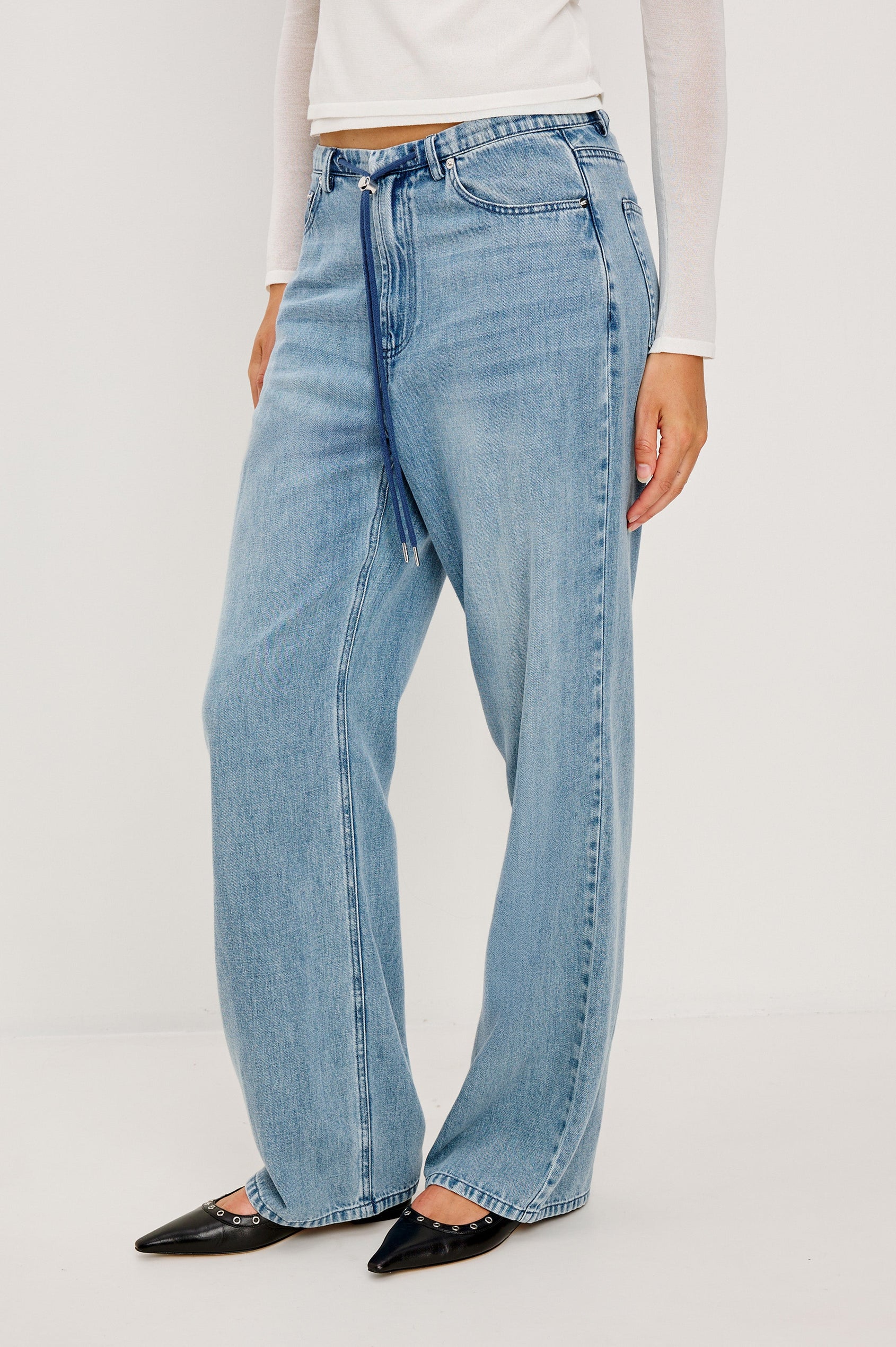 Normandie Lightweight 5-Pocket Denim Wide Leg Pant with front zipper button fly and a drawstring tie at waist in Antique Blue Colorway. Front View Featured on Model.