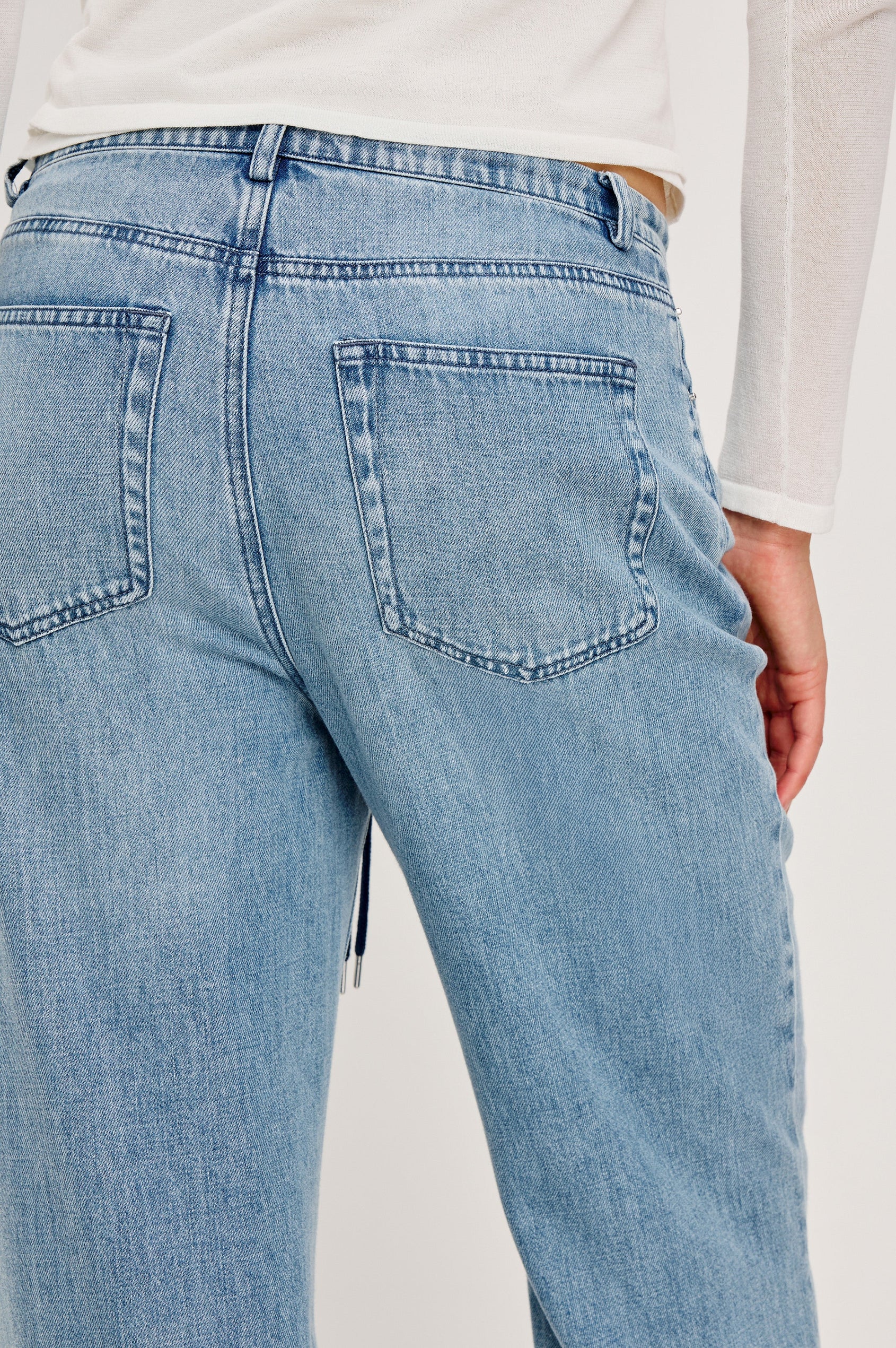 Normandie Lightweight 5-Pocket Denim Wide Leg Pant with front zipper button fly and a drawstring tie at waist in Antique Blue Colorway. Back View Featured on Model.