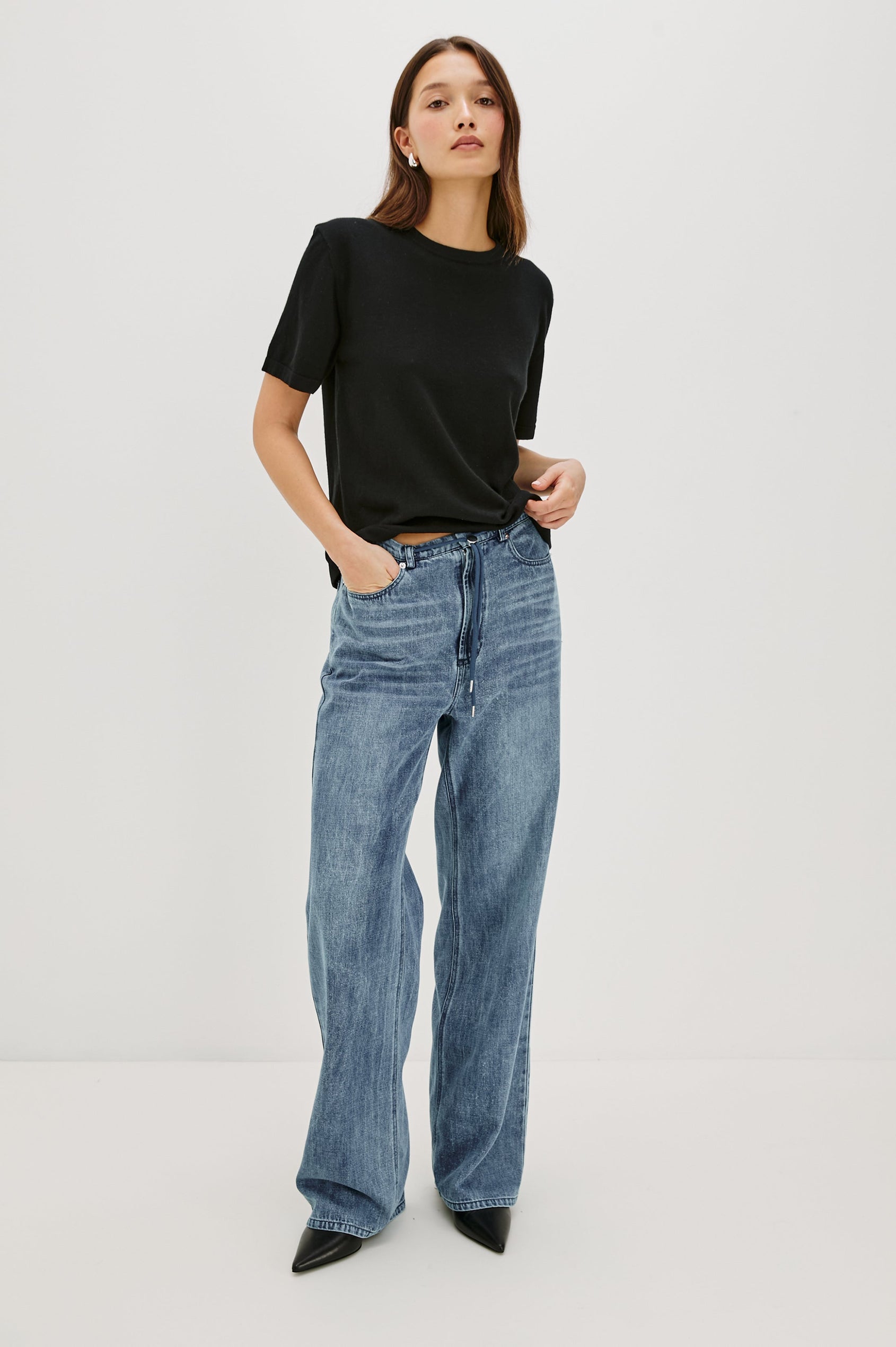 Normandie Lightweight 5-Pocket Denim Wide Leg Pant with front zipper button fly and a drawstring tie at waist in Antique Blue Colorway. Front Full Body View Featured on Model.