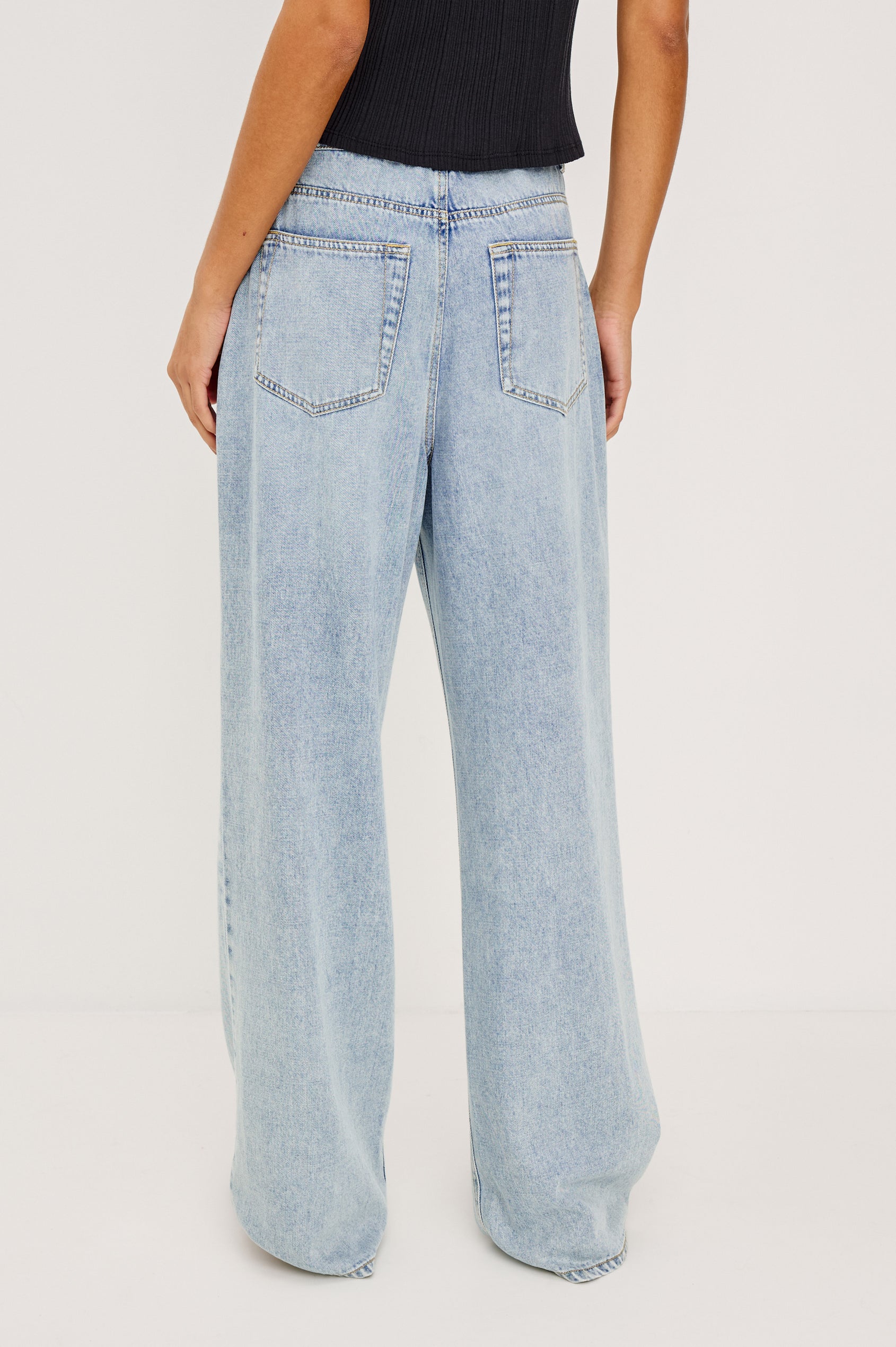 Normandie Pant in Cotton Lyocell Denim With Low-Slung Fit, Adjustable Toggle Drawstring Waist Ties, 5-Pockets, and Loose Fit in Sun Kissed Blue Colorway - Lower Body Back View Featured on Model