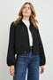 North Cropped Jacket with Button Closure, Puff Sleeves, Oversize Collar, a Toggle Hem, Two Front Pockets and a Horizontal Back Vent in Black Twill Colorway - Front View Featured on Model