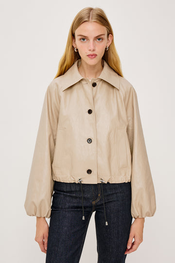 North Cropped Jacket in Faux Leather With Loose Boxy Fit, Oversized Collar, Front Buttons, Side Pockets, Drawstring Hem, Long Lantern Sleeves With Elastic Cuffs in Dune Colorway - Upper Body Front View Featured on Model