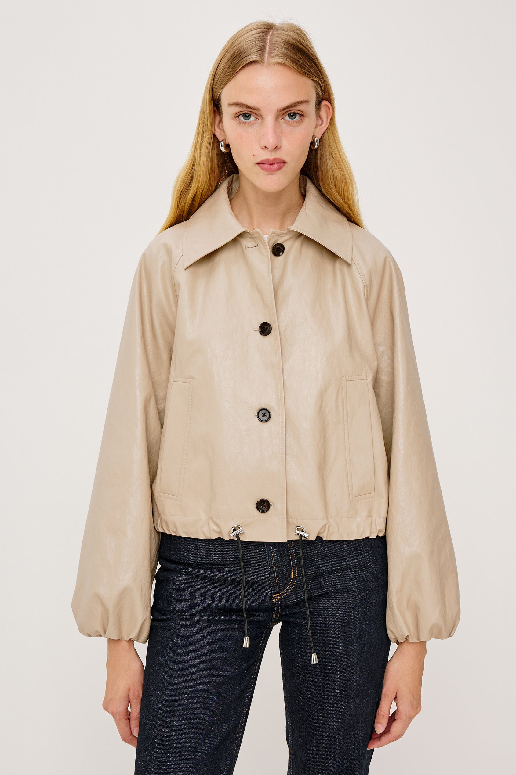 North Cropped Jacket with Button Closure, Puff Sleeves, Oversize Collar, a Toggle Hem, Two Front Pockets and a Horizontal Back Vent in Black Twill Colorway - Front View Featured on Model