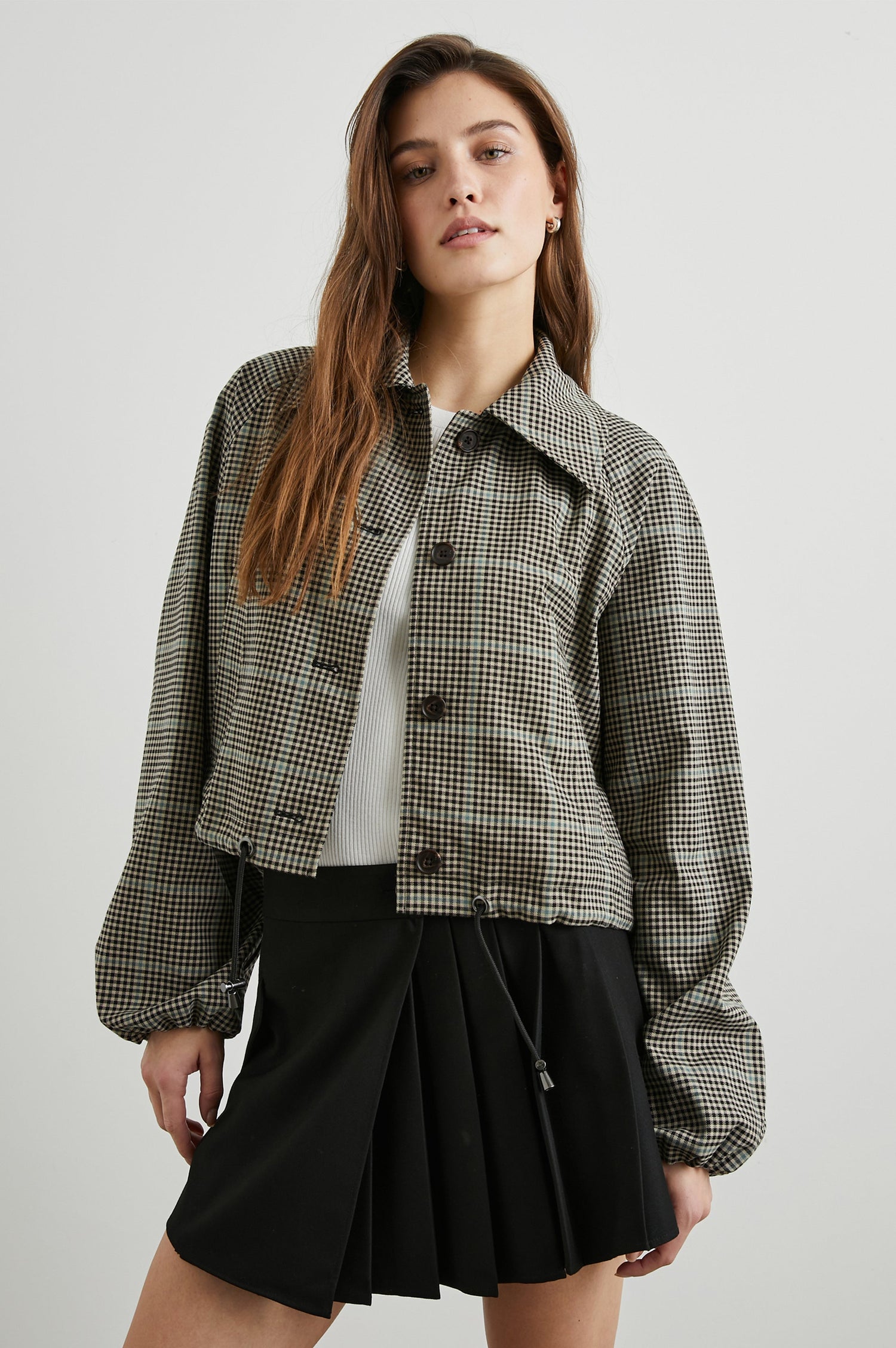 North Cropped Jacket with Button Closure, Puff Sleeves, Oversize Collar, a Toggle Hem, Two Front Pockets and a Horizontal Back Vent in Teal Multi Check Colorway, a Black, Tan and Teal Plaid - Front View Featured on Model