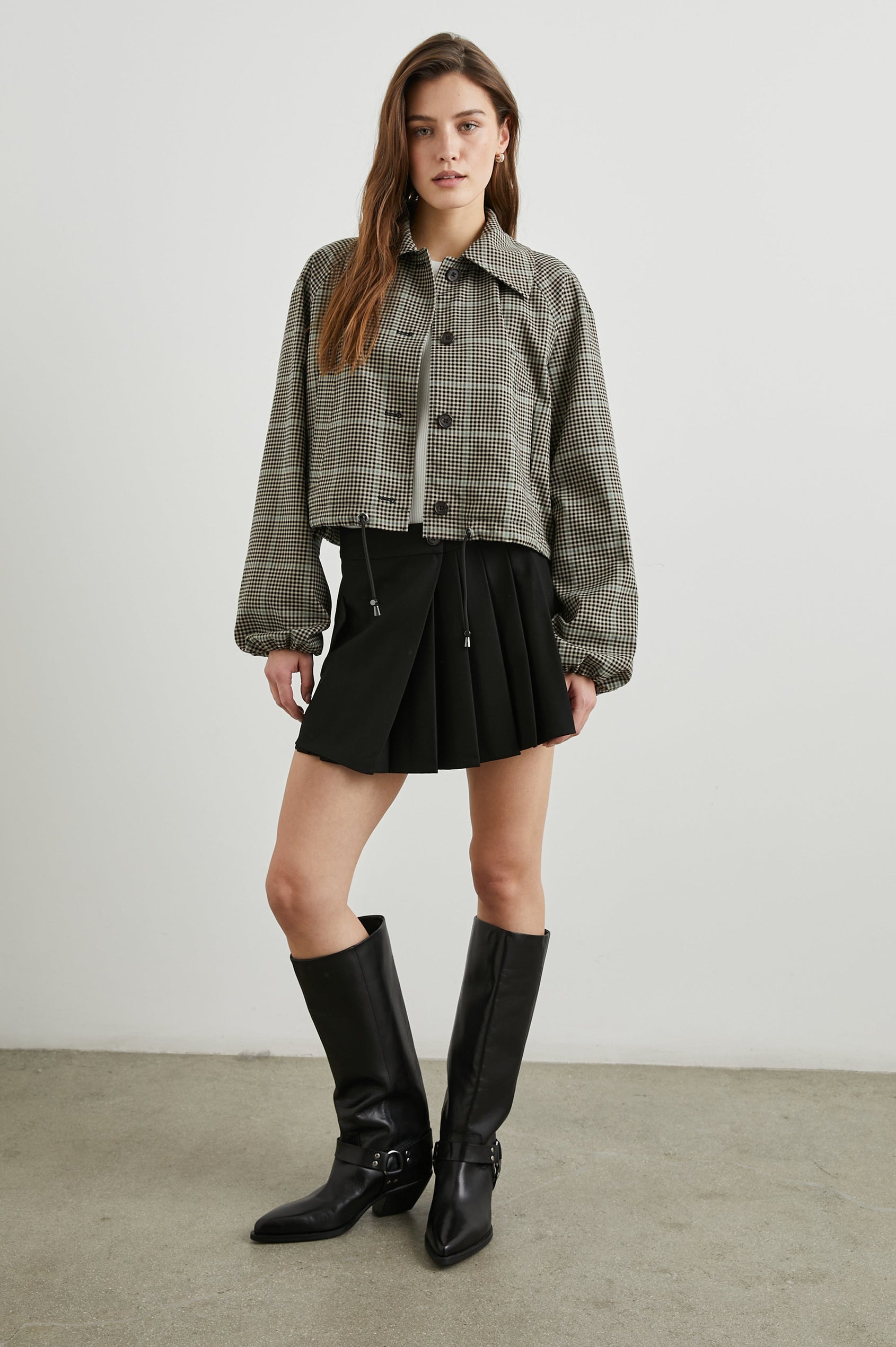 North Cropped Jacket with Button Closure, Puff Sleeves, Oversize Collar, a Toggle Hem, Two Front Pockets and a Horizontal Back Vent in Teal Multi Check Colorway, a Black, Tan and Teal Plaid - Front Full Body View Featured on Model