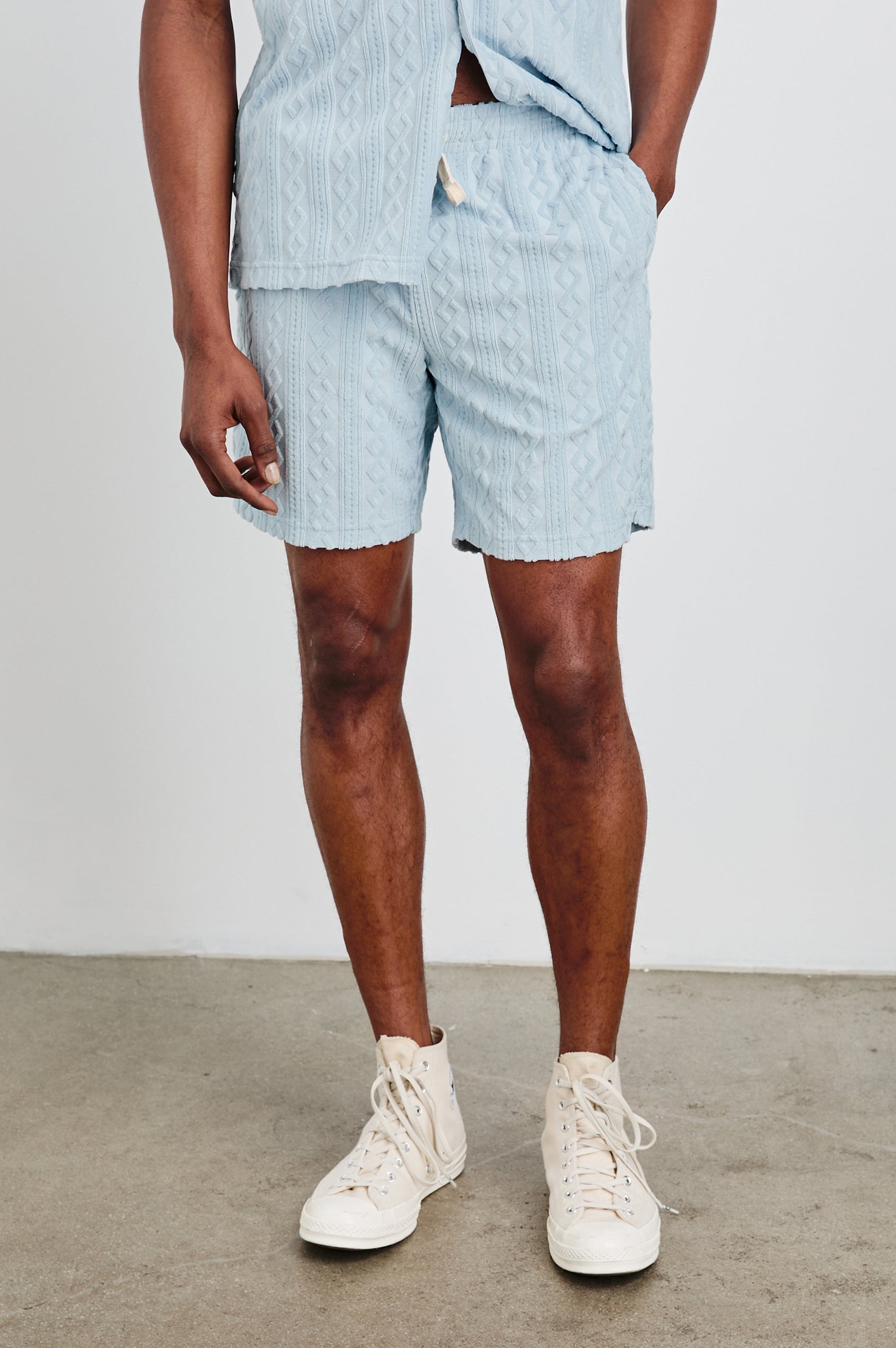 Nova Shorts with a Drawstring Waist, a Raised Jacquard Pattern, Two Front Pockets and a Back Patch Pocket in Coastal Blue Colorway - Front View Featured on Model