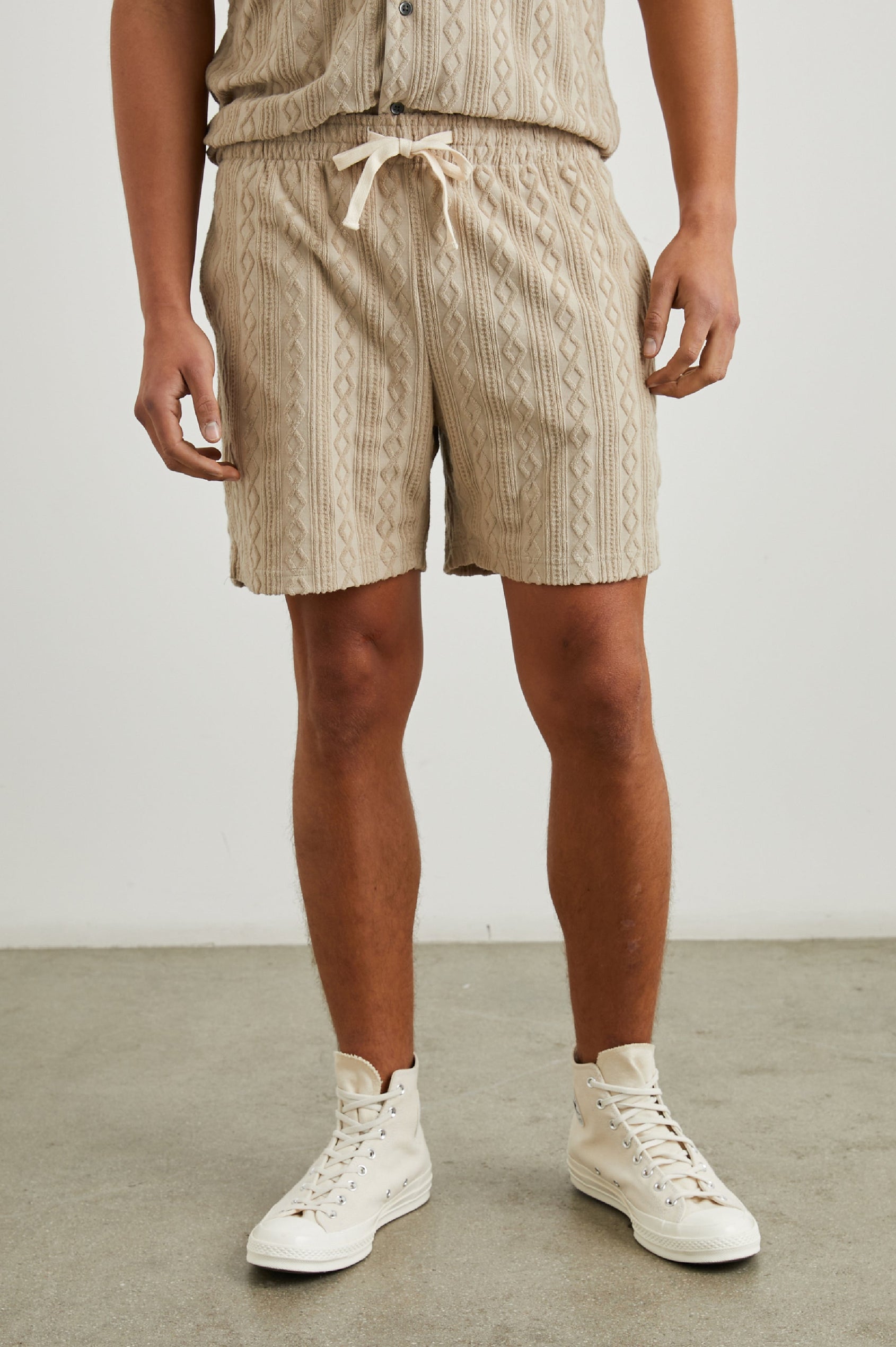 Nova Shorts with a Drawstring Waist, a Raised Jacquard Pattern, Two Front Pockets and a Back Patch Pocket in Craft Paper Colorway, a Light Brown - Front View Featured on Model