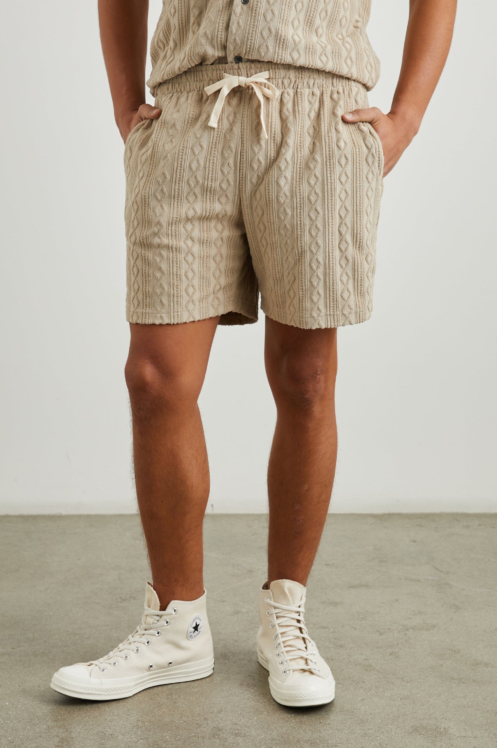 Nova Shorts with a Drawstring Waist, a Raised Jacquard Pattern, Two Front Pockets and a Back Patch Pocket in Craft Paper Colorway, a Light Brown - Front View Featured on Model