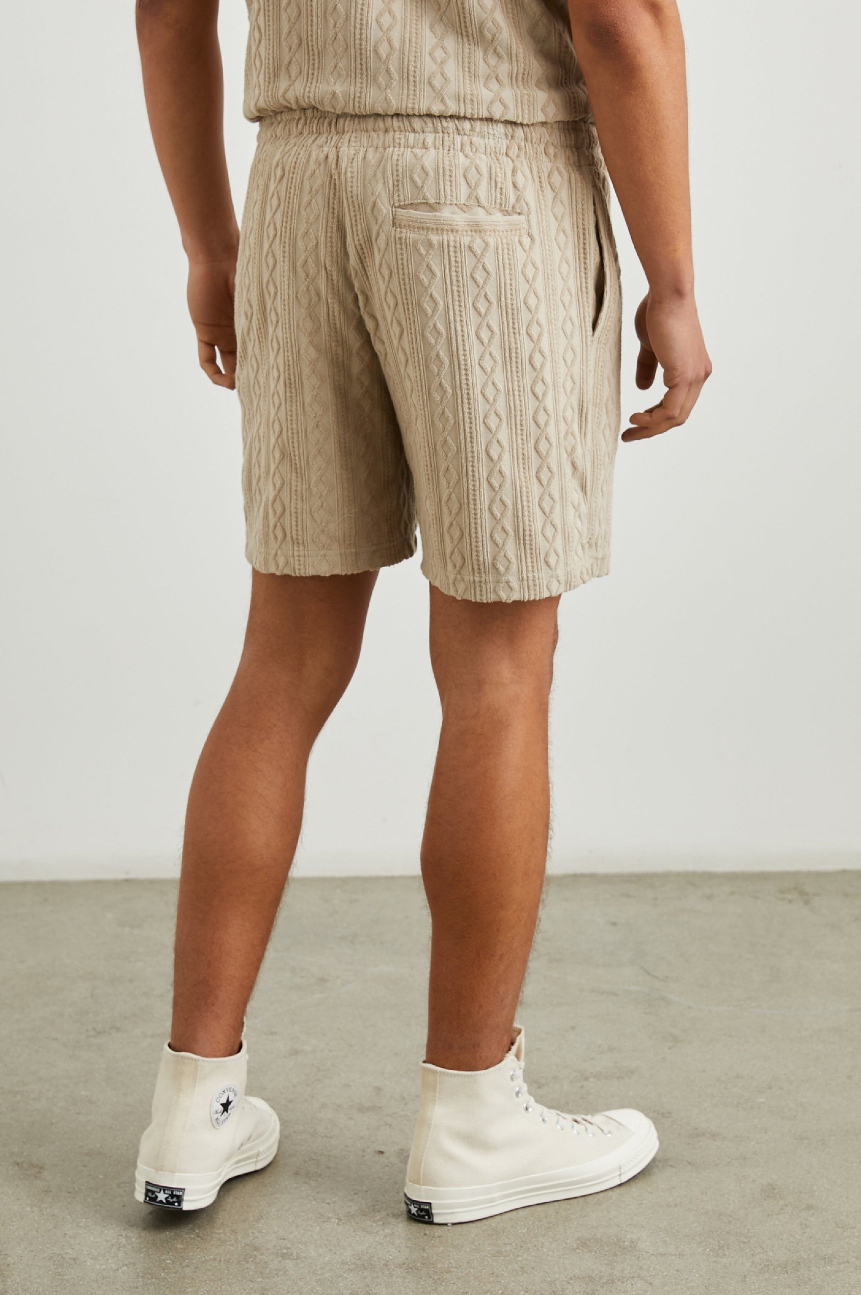 Nova Shorts with a Drawstring Waist, a Raised Jacquard Pattern, Two Front Pockets and a Back Patch Pocket in Craft Paper Colorway, a Light Brown - Back View Featured on Model