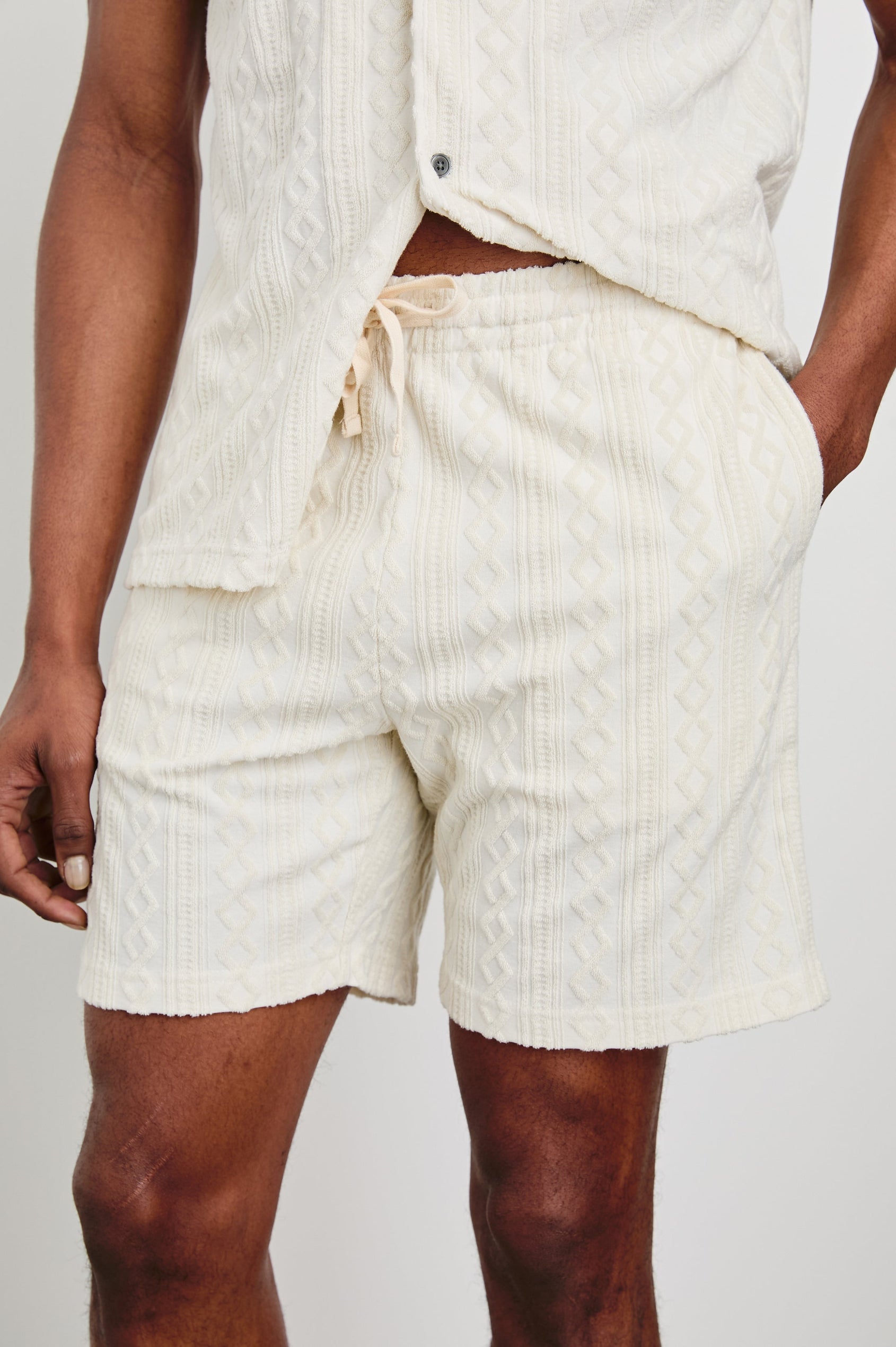 Nova Shorts with a Drawstring Waist, a Raised Jacquard Pattern, Two Front Pockets and a Back Patch Pocket in Ecru Colorway - Front View Featured on Model