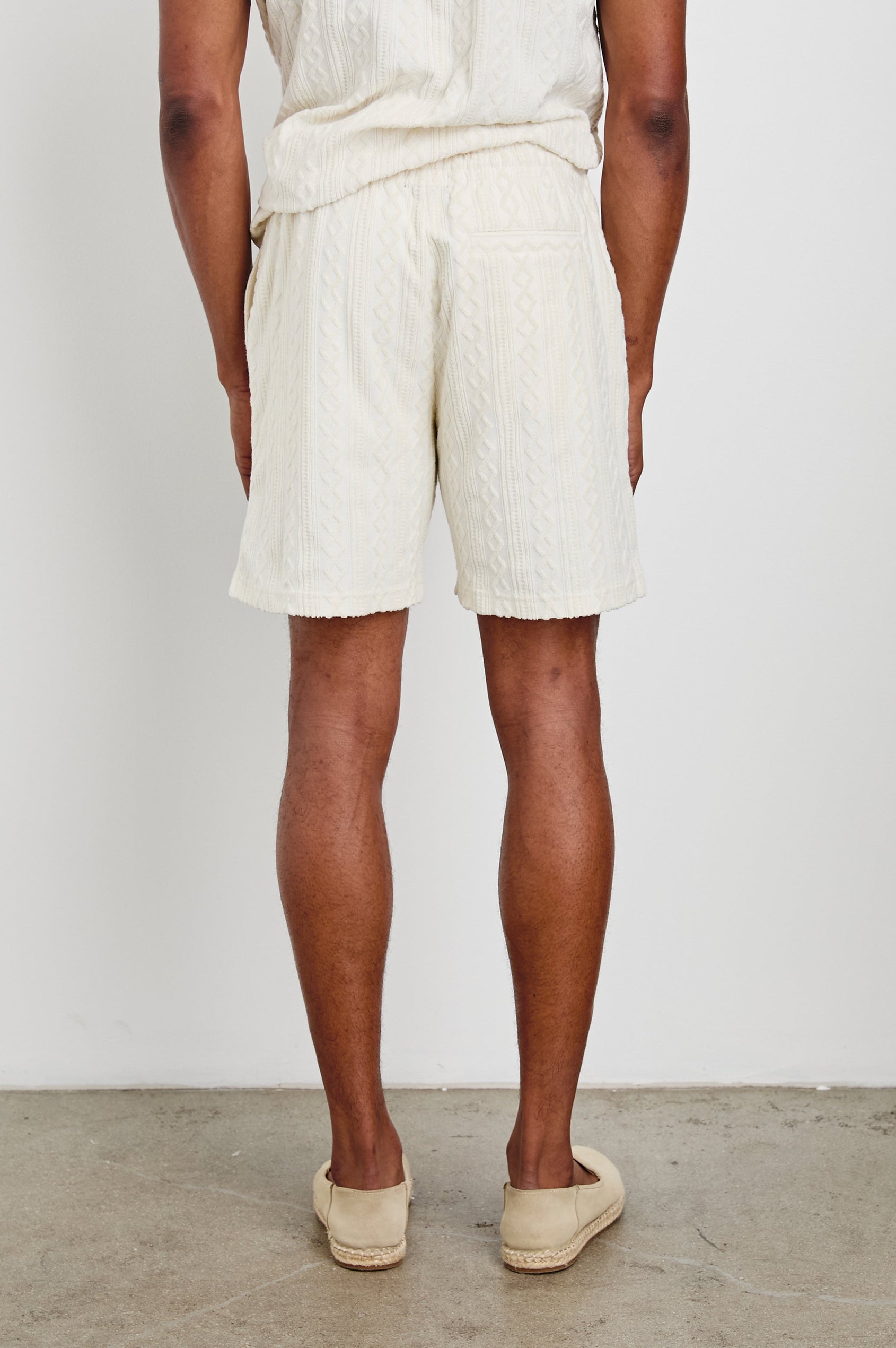 Nova Shorts with a Drawstring Waist, a Raised Jacquard Pattern, Two Front Pockets and a Back Patch Pocket in Ecru Colorway - Back View Featured on Model