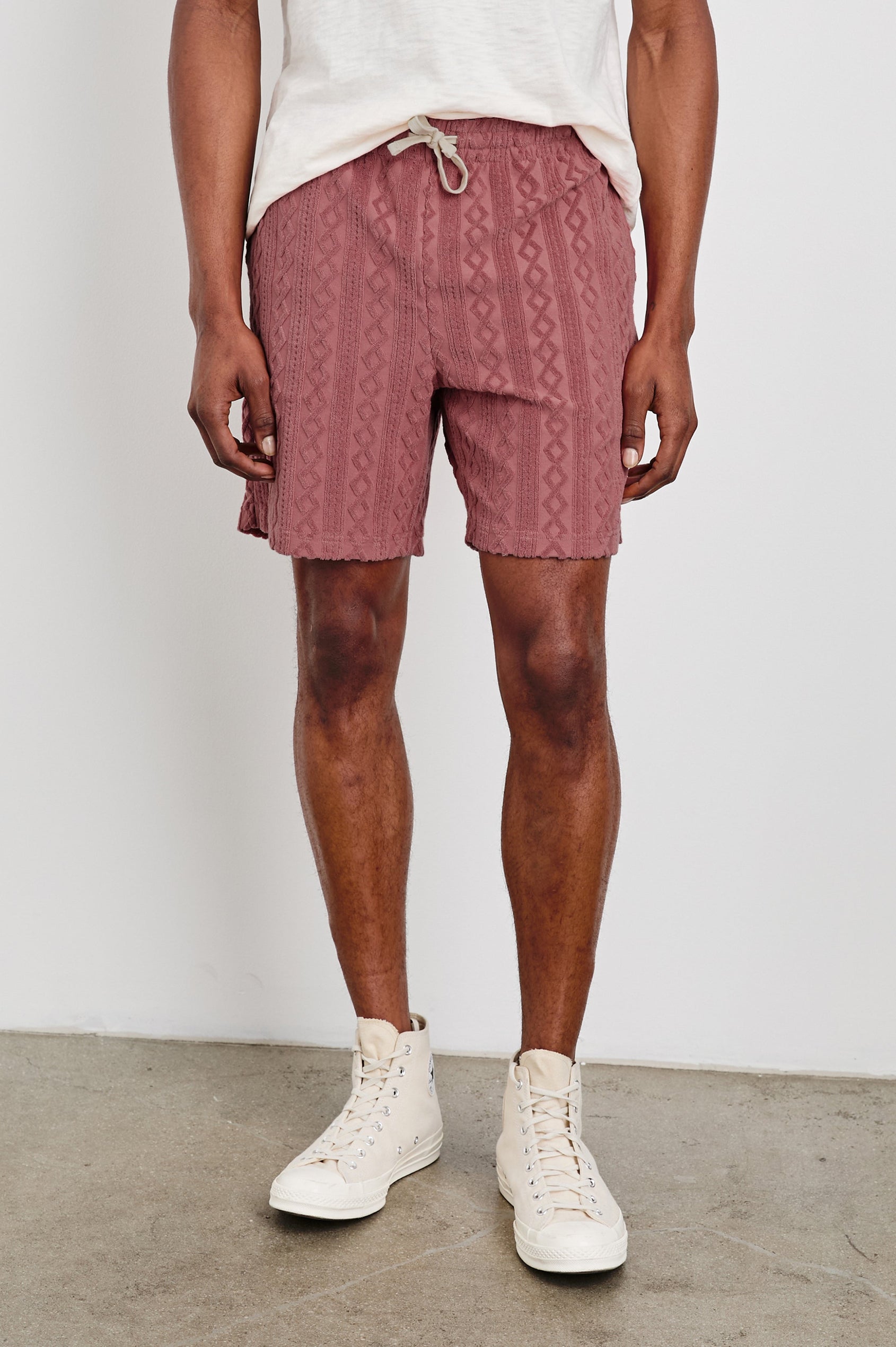 Nova terry shorts with raised jacquard pattern and front drawstring in Faded Red - front view on model
