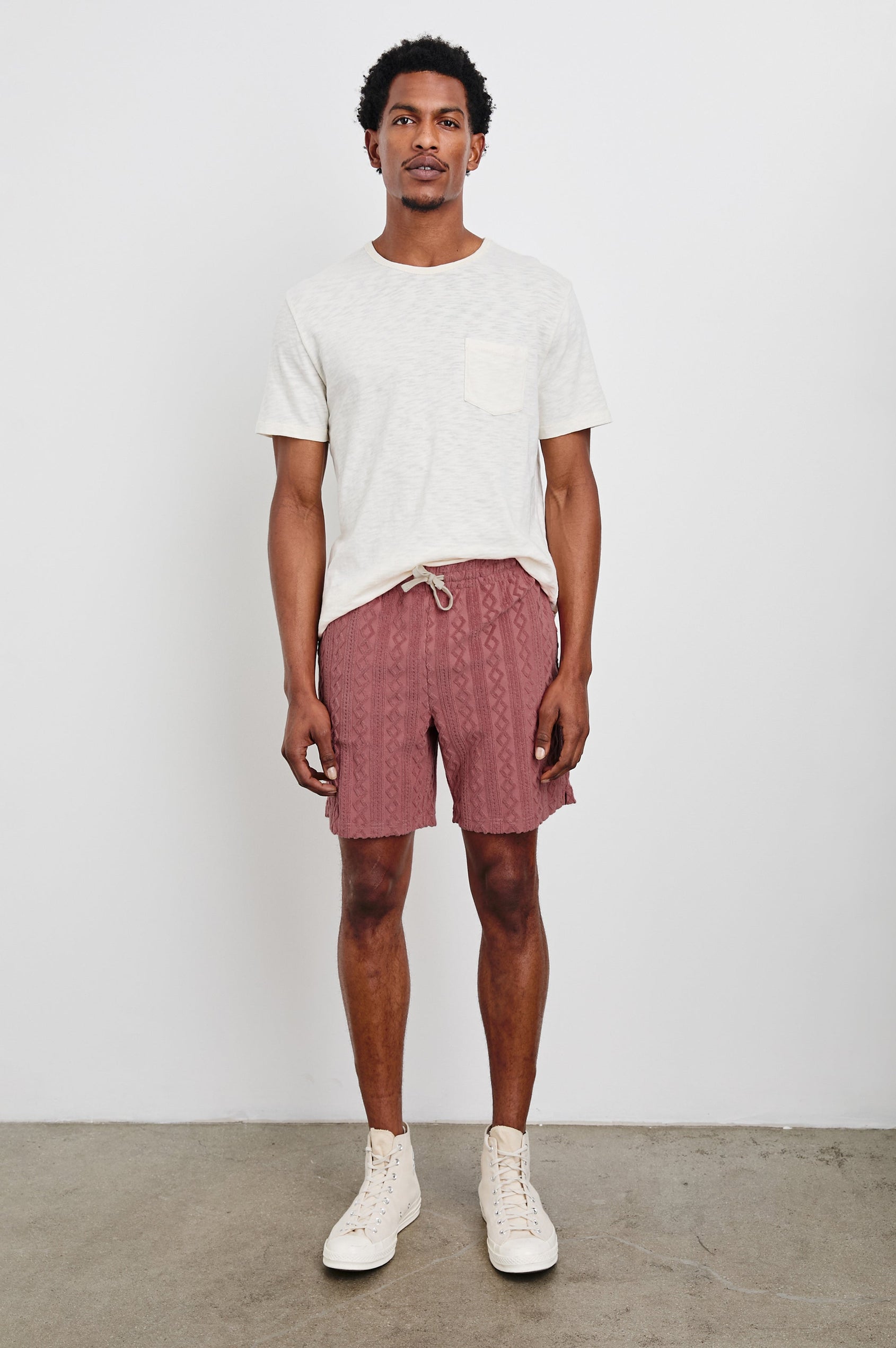 Nova terry shorts with raised jacquard pattern and front drawstring in Faded Red - full body front view on model