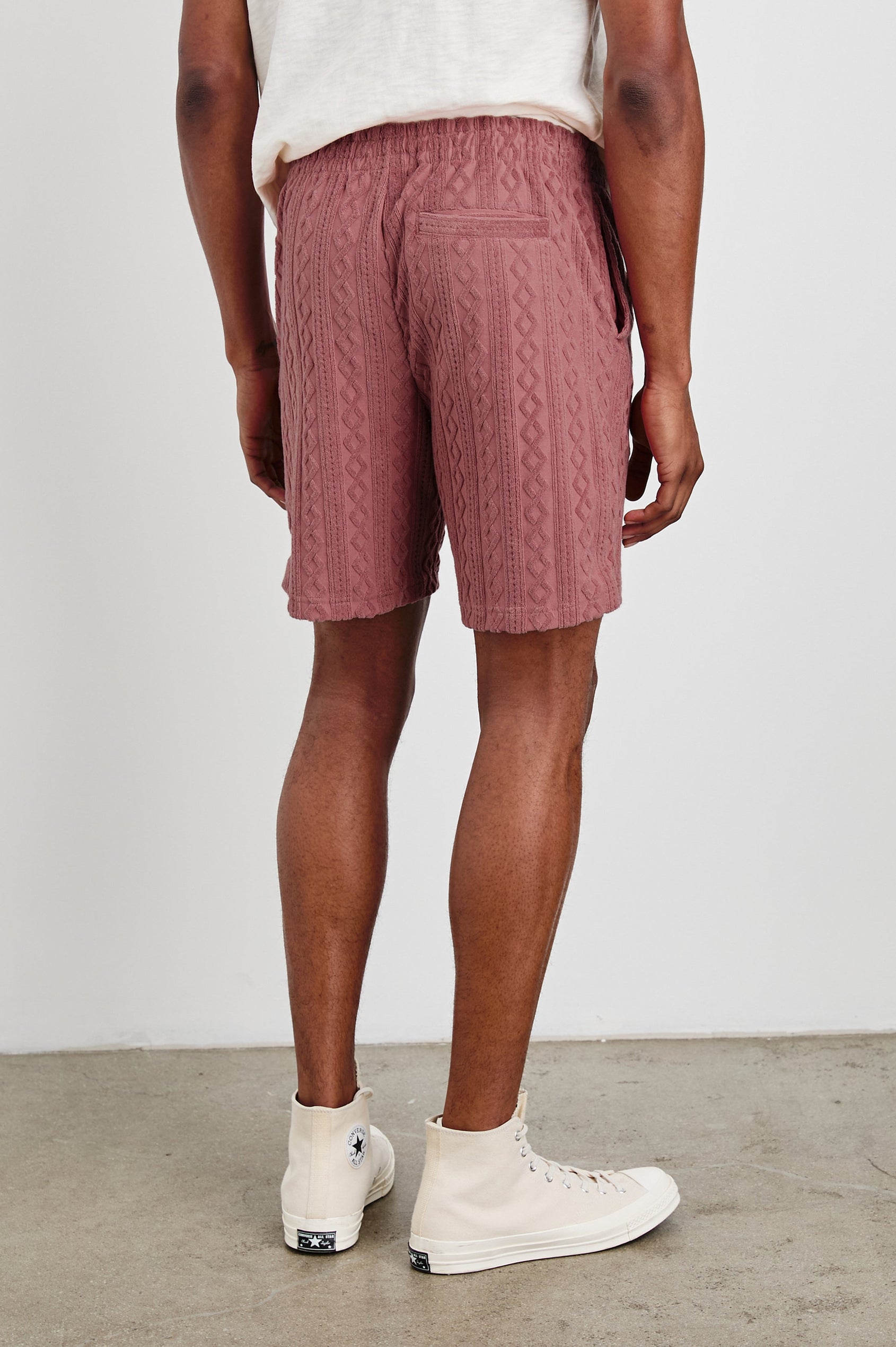 Nova terry shorts with raised jacquard pattern and front drawstring in Faded Red - back view on model with pockets