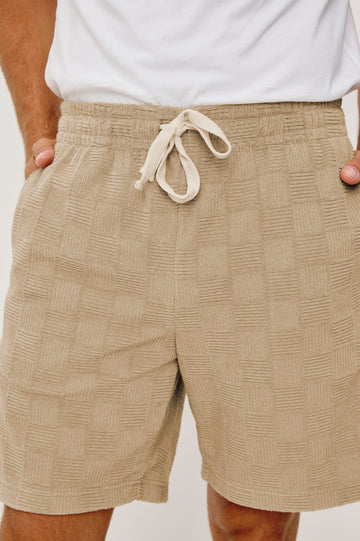 Nova Short in French Terry With Raised Jacquard Pattern, Side Pockets, and Drawstring Waist Ties in Grange Craft Paper Colorway - Lower Body Close Up View Featured on Model