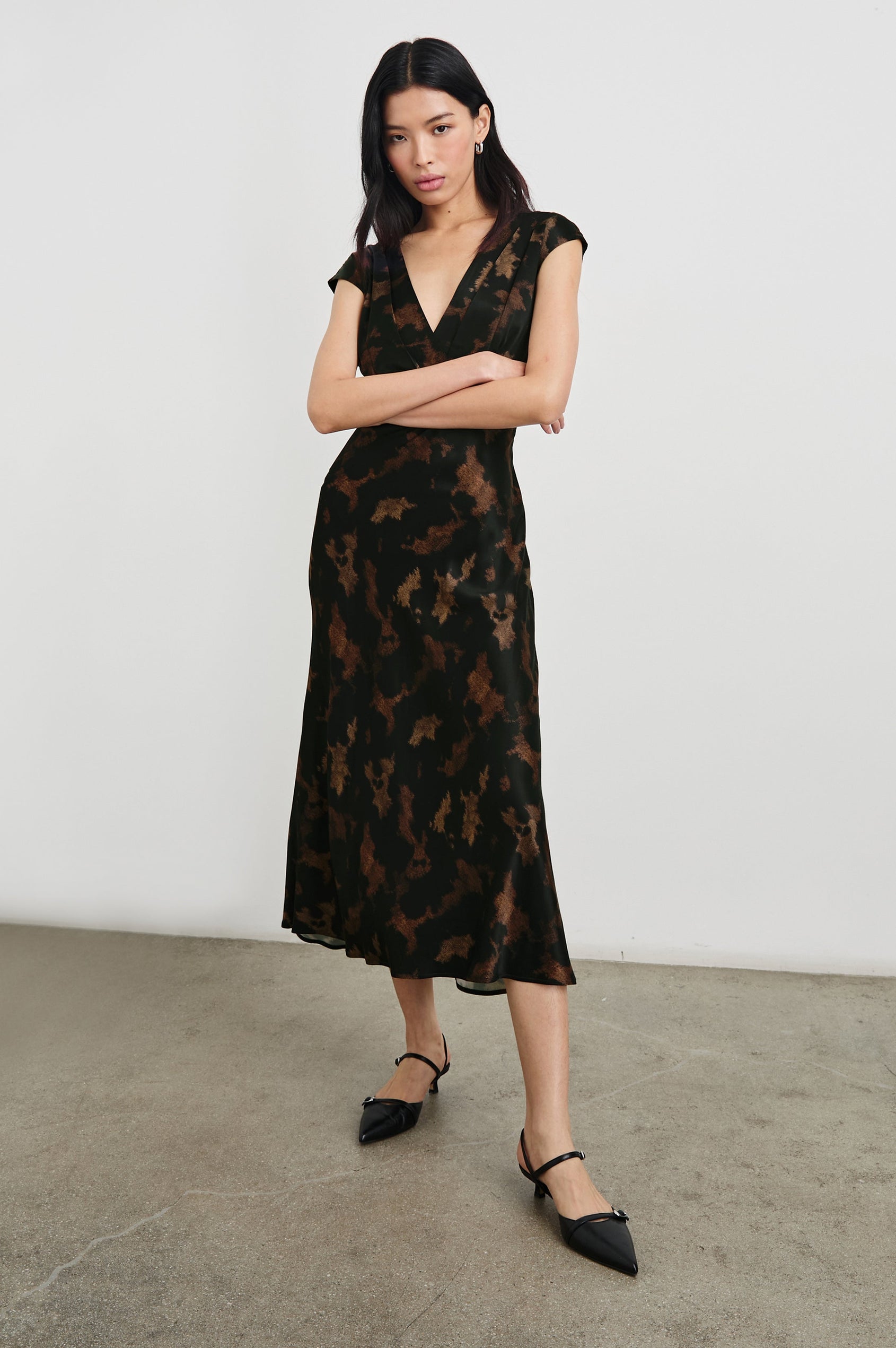 Odella Midi Dress with Cap Sleeves, Double Front Crossover Bodice, Deep V Neck and a Back Neck Tie in Diffused Sandstone Colorway, a pattern in Browns and black - Front Full Body View Featured on Model 