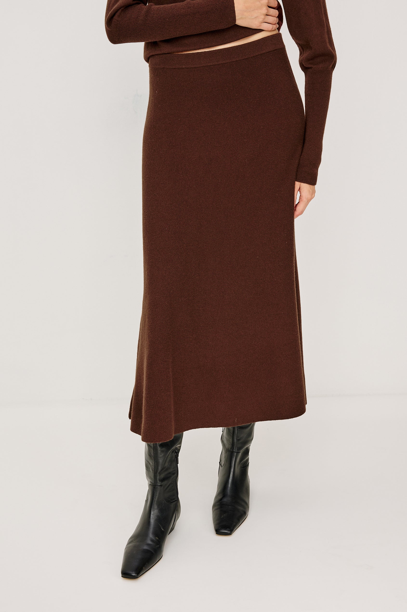 Odita High-Waisted A-lIne Midi Skirt in Wool Blend in Bordeaux Colorway - Close Up Lower Body Front View Featured on Model