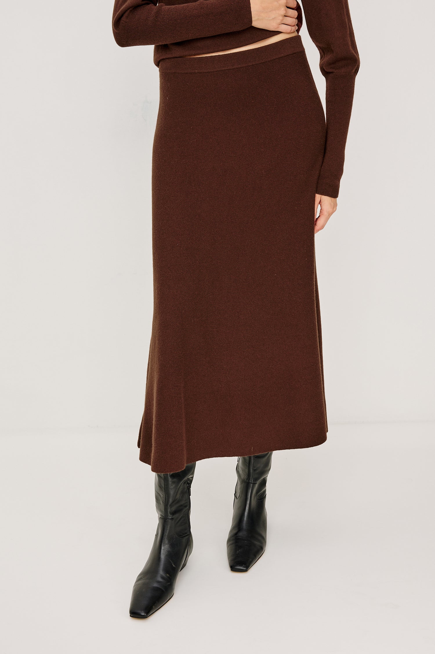 Odita High-Waisted A-lIne Midi Skirt in Wool Blend in Bordeaux Colorway - Close Up Lower Body Front View Featured on Model