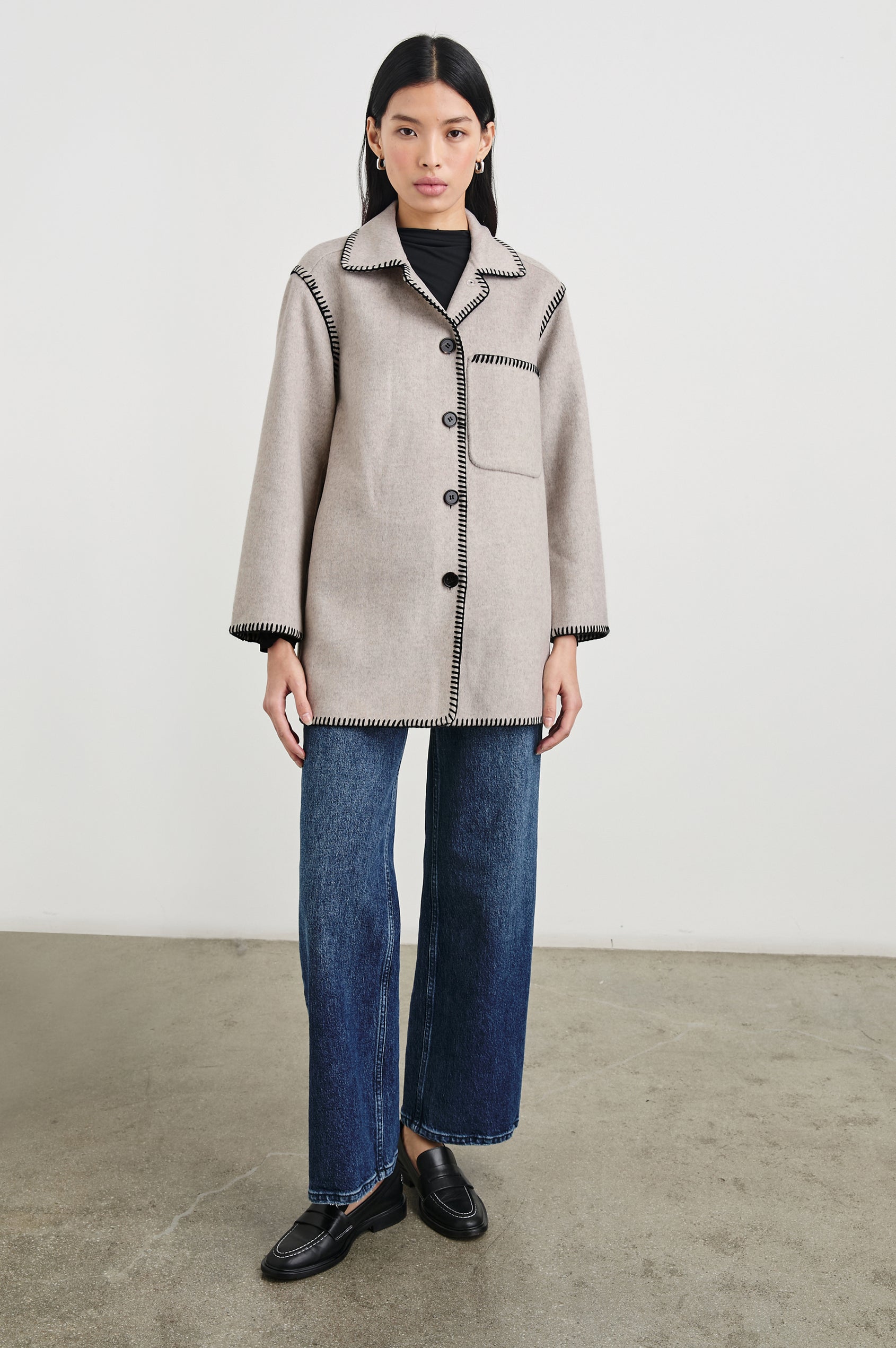 Odyssey Jacket with Four Button Closure and a Chest Patch Pocket in Oatmeal Colorway, with black contrast stitching - Front Full Body View Featured on Model