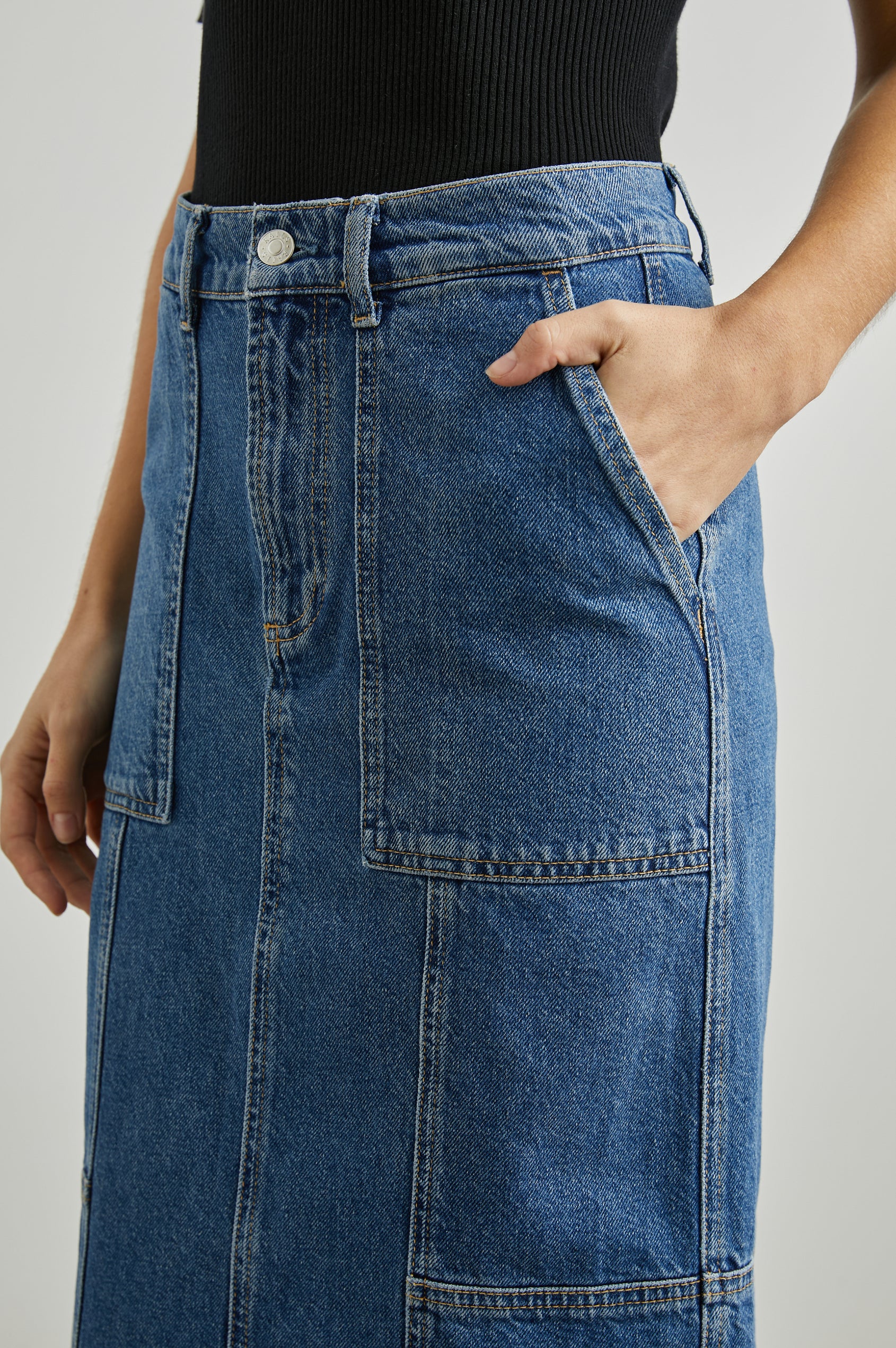 Olympic Midi Denim Skirt with Belt Loops, Additional Seams, Two Large Front Pockets and Two Back Welt Pockets in Sorrento Colorway, a Blue - Front View Featured on Model