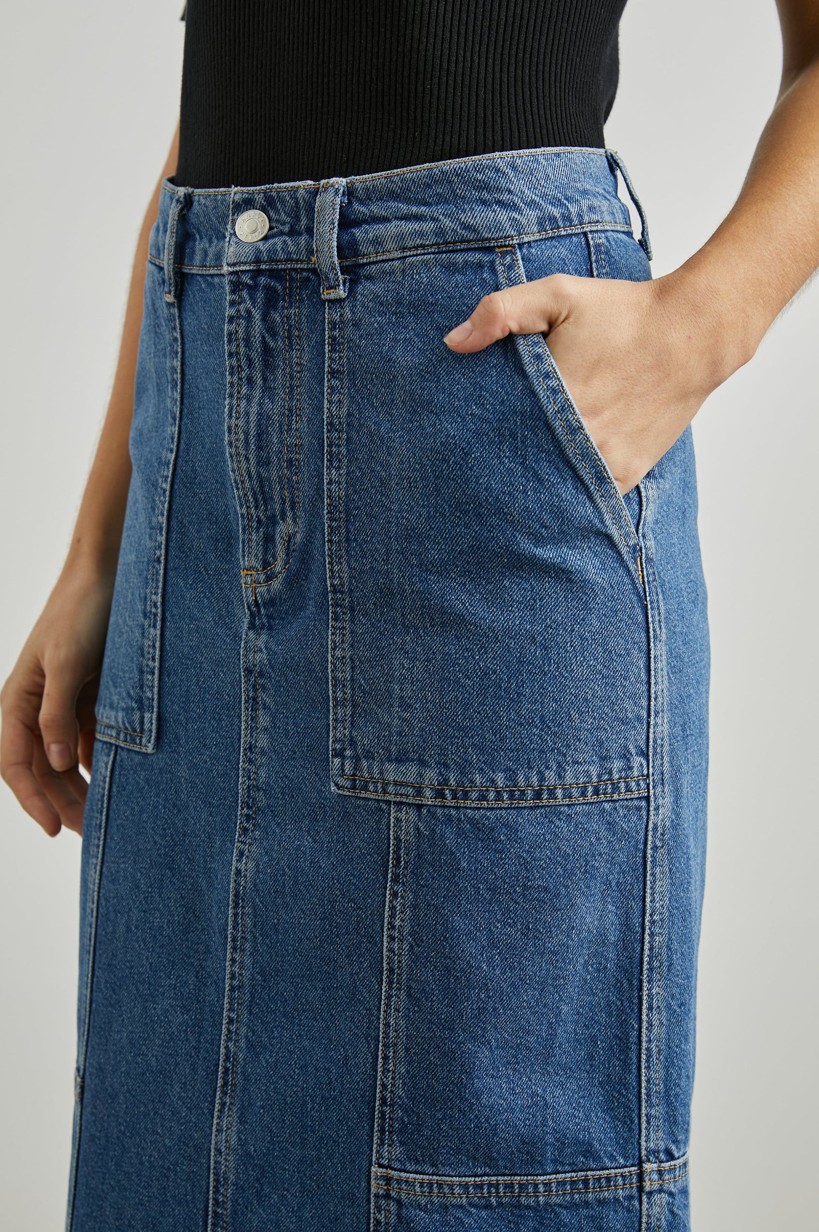 Olympic Midi Denim Skirt with Belt Loops, Additional Seams, Two Large Front Pockets and Two Back Welt Pockets in Sorrento Colorway, a Blue - Front View Featured on Model