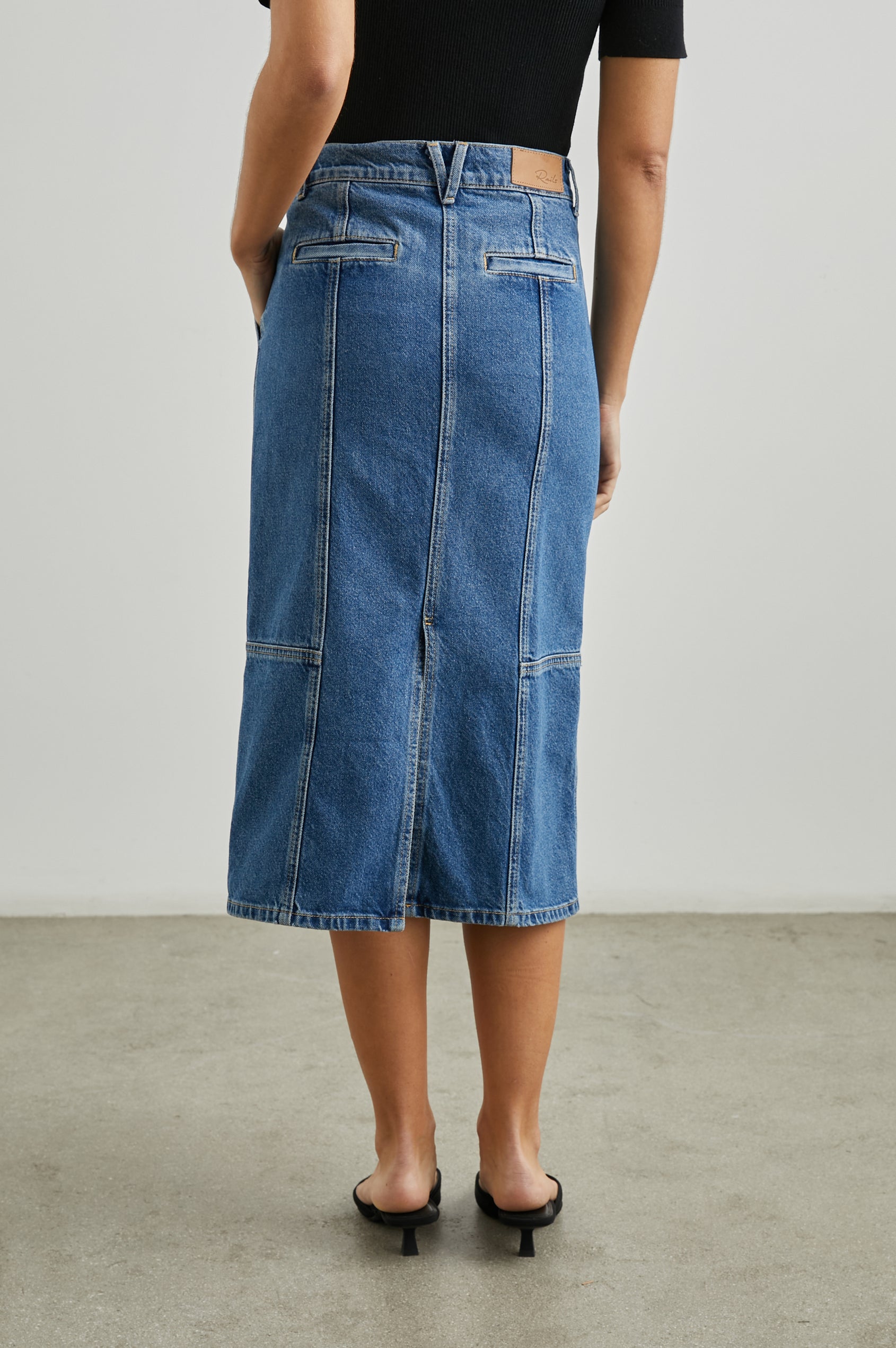 Olympic Midi Denim Skirt with Belt Loops, Additional Seams, Two Large Front Pockets and Two Back Welt Pockets in Sorrento Colorway, a Blue - Back View Featured on Model