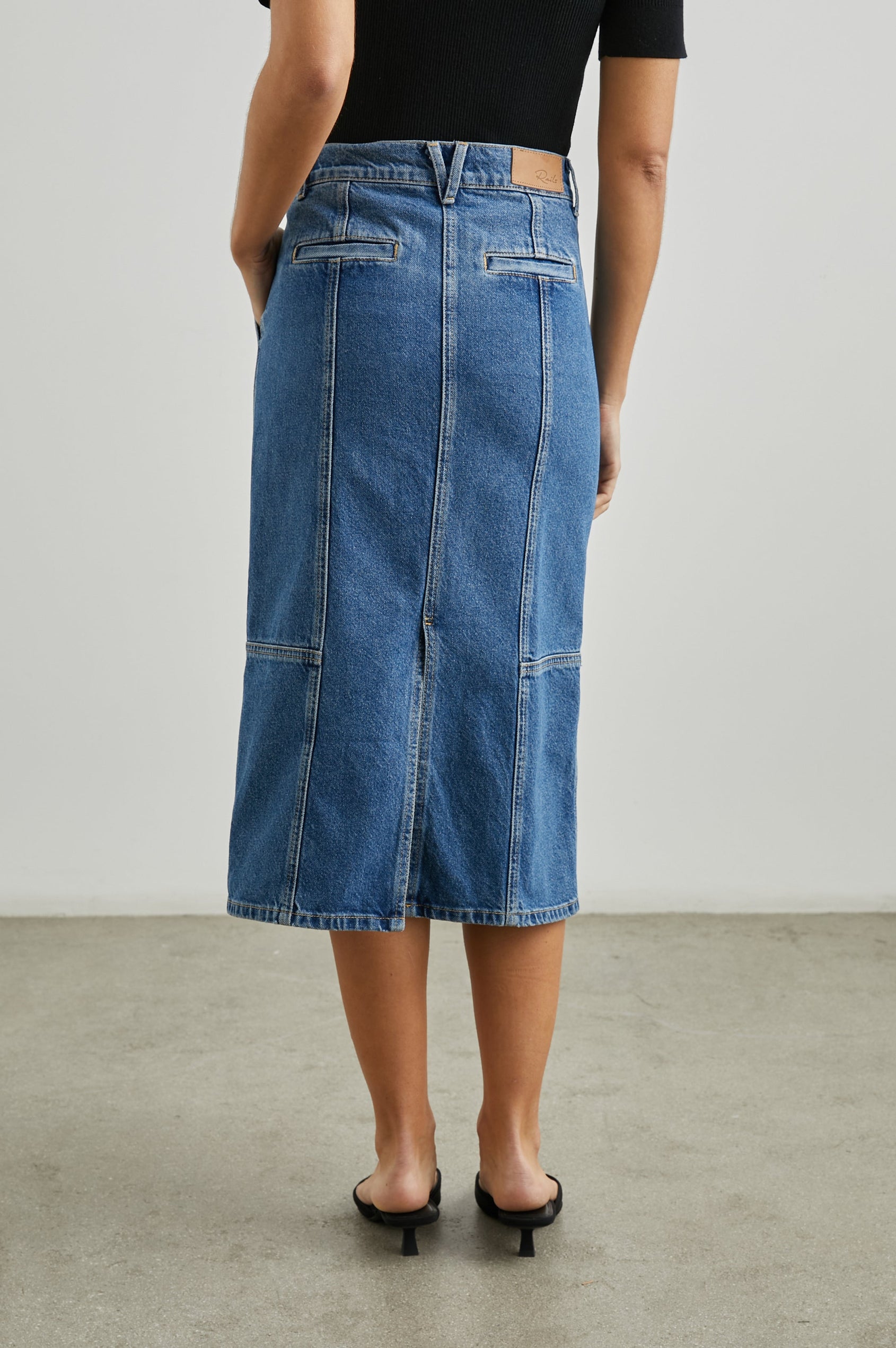 Olympic Midi Denim Skirt with Belt Loops, Additional Seams, Two Large Front Pockets and Two Back Welt Pockets in Sorrento Colorway, a Blue - Back View Featured on Model