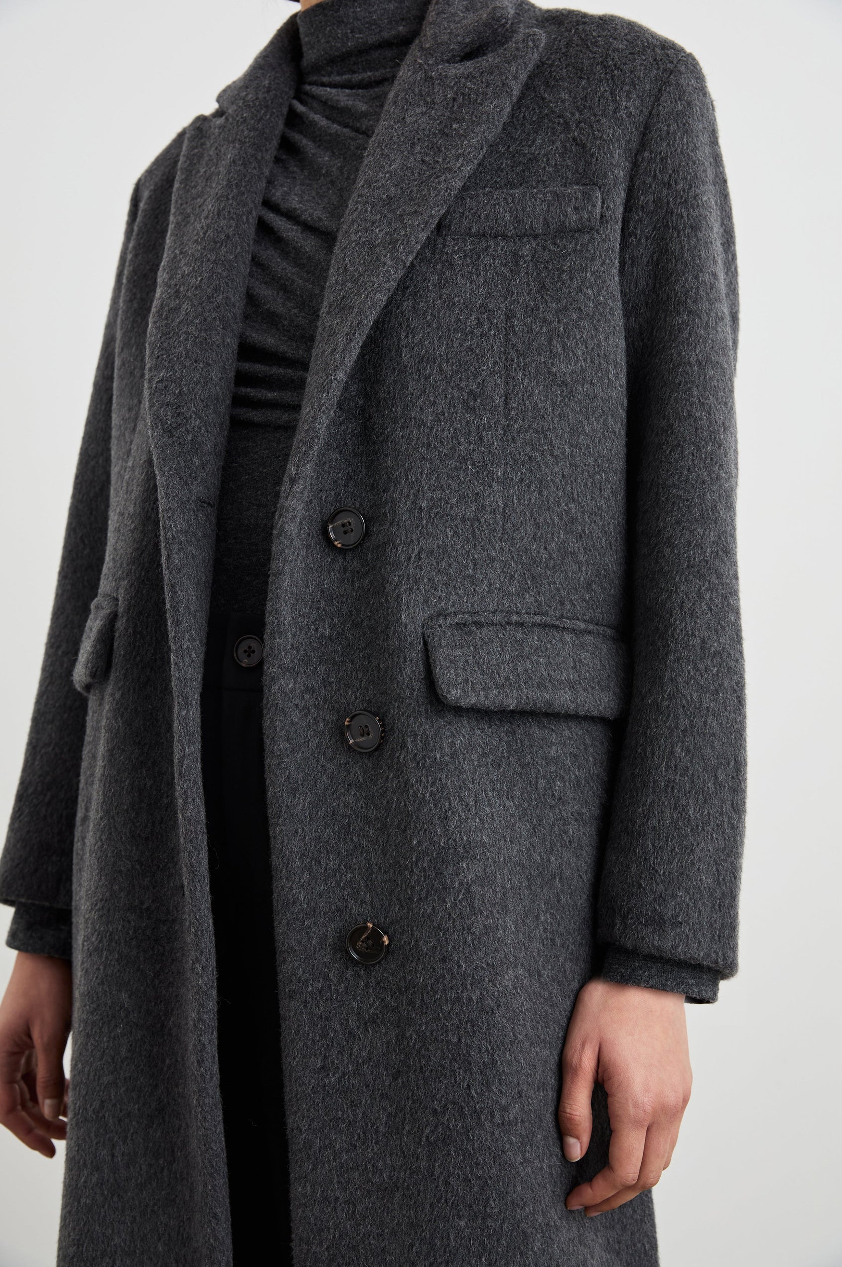 Opera Below-the-Knee Length Coat with V Neck, Three-Button Closure and Two Front Flap Patch Pockets in Charcoal Colorway - Front View Featured on Model