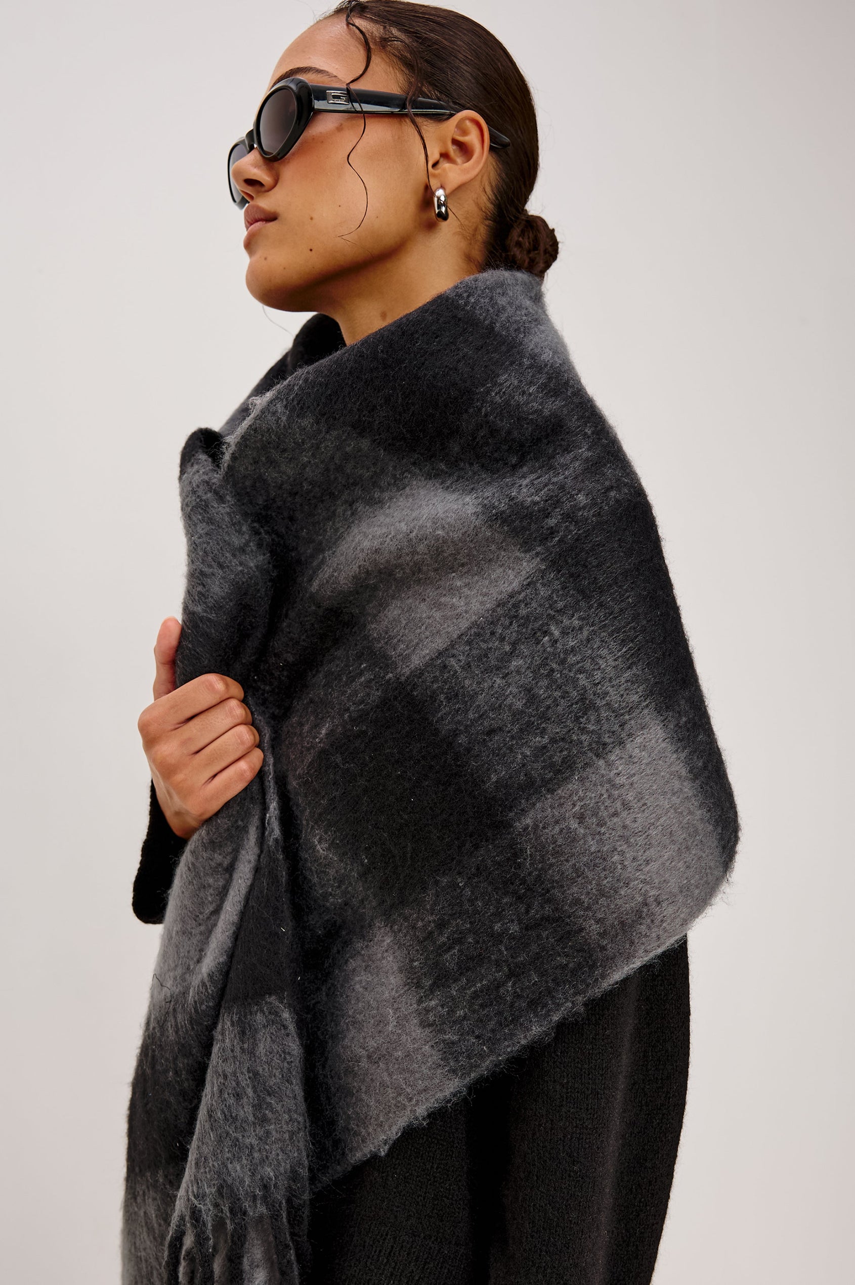 Oslo Scarf with Twisted Tassels and a Checkered Pattern in Charcoal Black Colorway - Front Side View Featured on Model